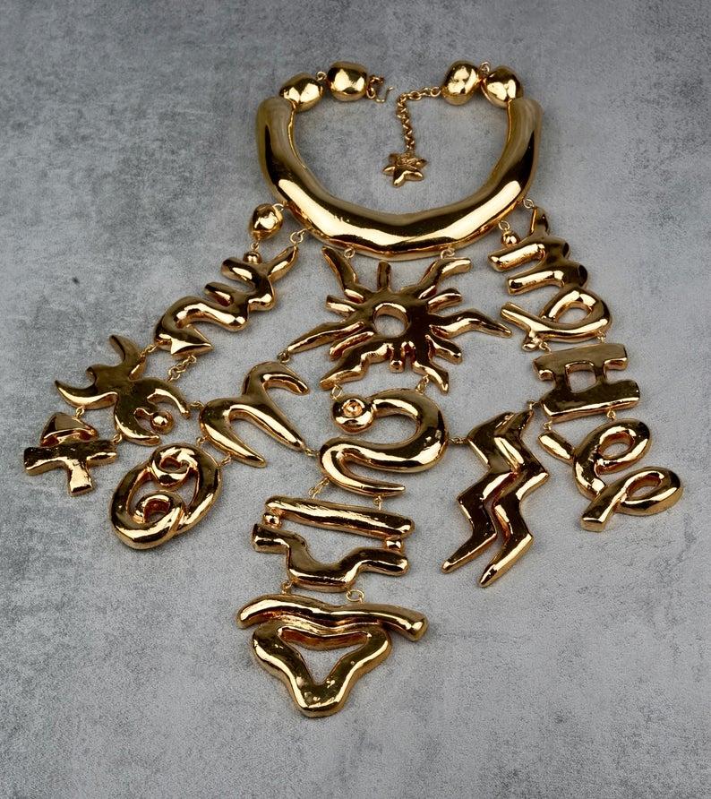 Vintage CHRISTIAN LACROIX Iconic Emblem Plastron Breastplate Choker Necklace

Measurements:
Height: 10.82 inches (27.5 cm)
Width: 11.81 cm (30 cm)
Wearable Length: 12.99 inches to 15.75 inches (33 cm to 40 cm)

Runway piece that is almost impossible