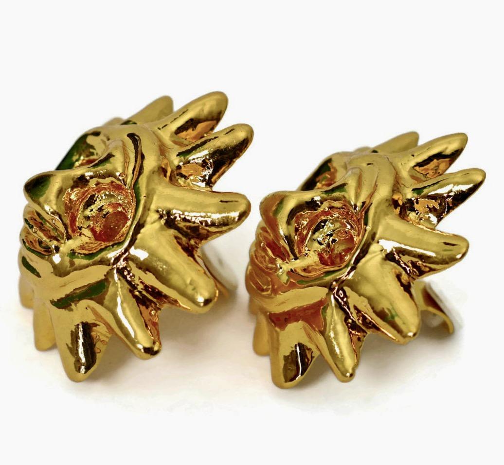 Vintage CHRISTIAN LACROIX Iconic Sun Face Earrings

Measurements:
Height: 1 7/8 inches
Width: 1 7/8 inches
Depth: 3/4 inch

Features:
- 100% Authentic CHRISTIAN LACROIX.
- Huge 3D sun face earrings.
- Gold tone.
- Signed Christian Lacroix CL Made in
