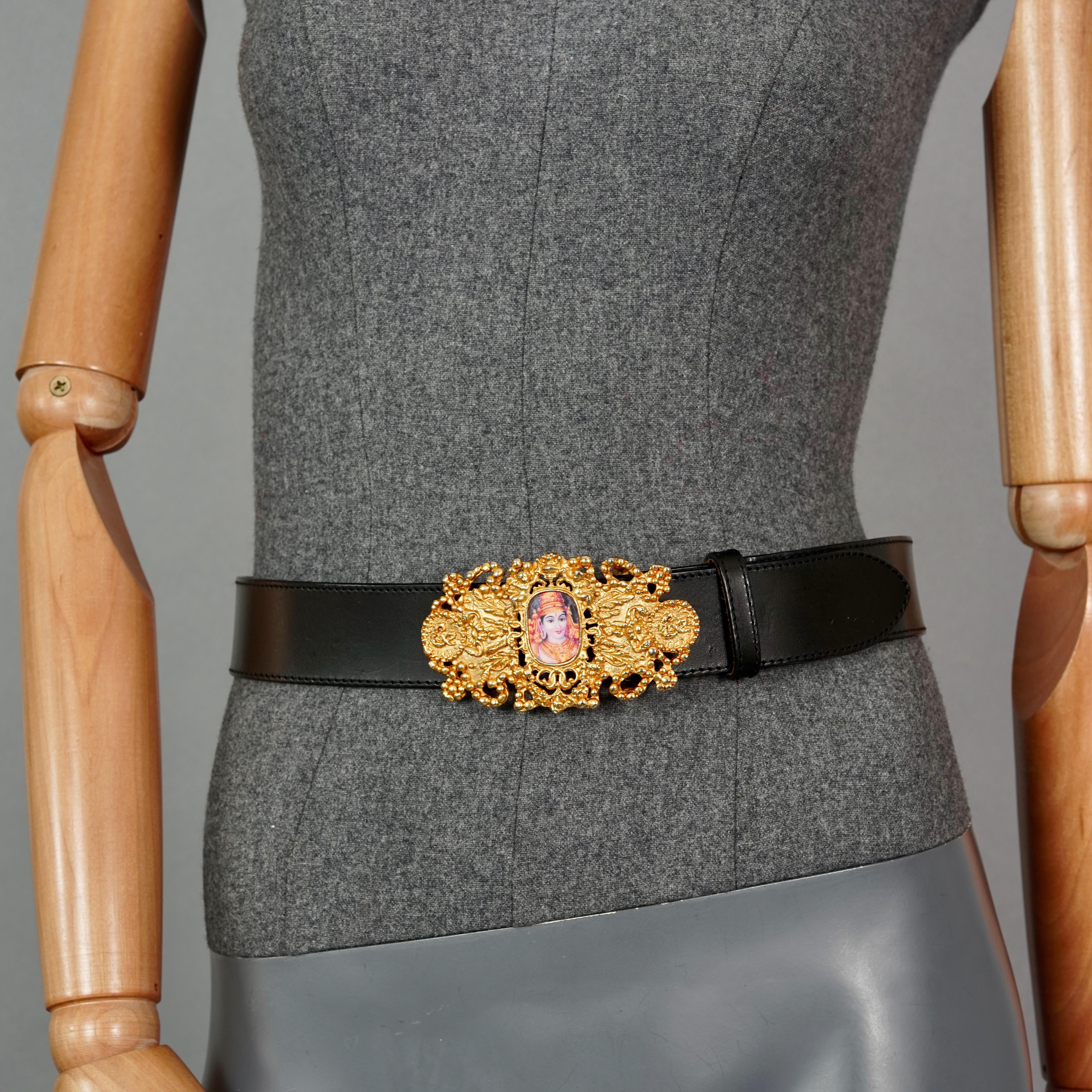Vintage CHRISTIAN LACROIX Indian Maharani Profile Gilt Frame Buckle Belt

Measurements:
Buckle Height: 2.05 inches (5.2 cm)
Buckle Width: 3.94 inches (10 cm)
Wearable Length: 27.55 inches to 29.52 inches (70 cm to 75 cm) adjustable

Features:
- 100%