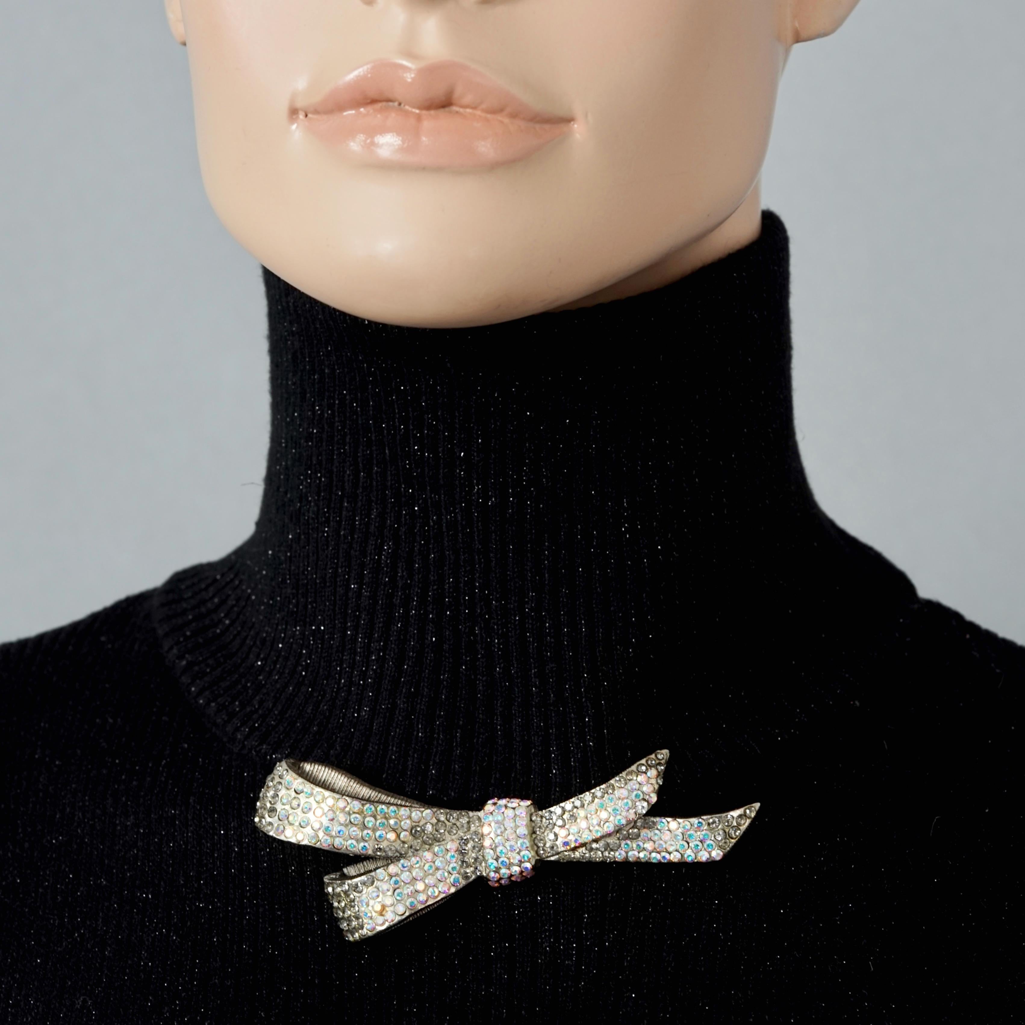 Vintage CHRISTIAN LACROIX Iridescent Jewelled Bow Patinated Brooch

Measurements:
Height: 1.53 inches (3.9 cm)
Length: 3.85 inches (9.8 cm)

Features:
- 100% Authentic CHRISTIAN LACROIX by Xavier Loubens.
- Bow brooch studded with clear and