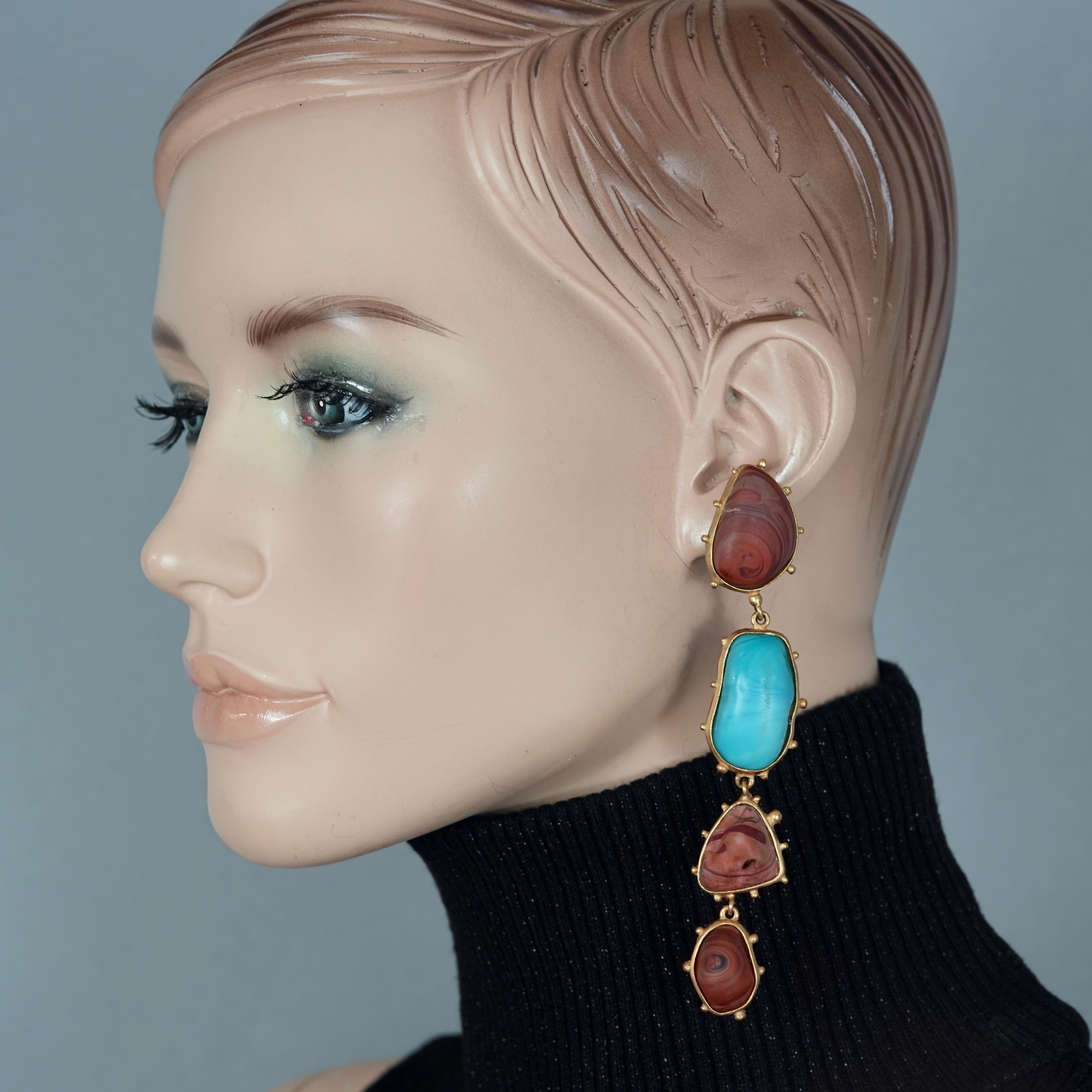 Vintage CHRISTIAN LACROIX Marble Turquoise Brown Dangling Earrings

Measurements:
Height: 4.56 inches (11.6 cm)
Width: 0.86 inch (2.2 cm)
Weight per Earring: 32 grams

Features:
- 100% Authentic Christian Lacroix.
- Marbled turquoise and brown