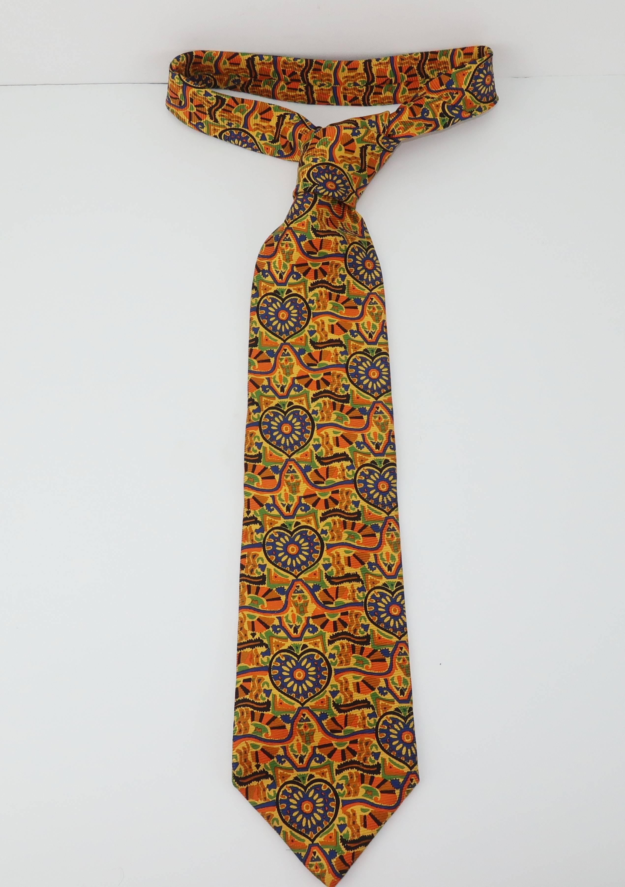 Christian Lacroix, the king of 1980's flamboyant designs, sheds some light (and a lot of pizazz) on men's necktie fashions with this colorful silk tie.  The opulent pattern hints at heart shapes with an abstractly exotic background.  Golden yellows