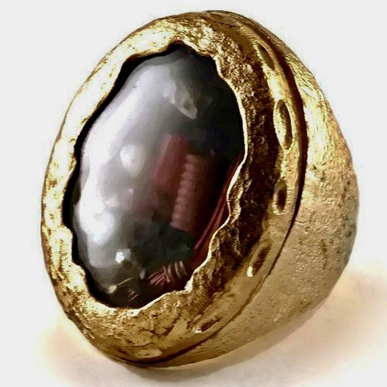 Vintage CHRISTIAN LACROIX Movable Nautical Charm Statement Ring

Measurements:
Center Piece Height: 1 2/8 inches (3.17 cm)

Features:
- 100% Authentic CHRISTIAN LACROIX.
- Textured massive ring.
- Movable nautical motif rice pearls, shells, beads,
