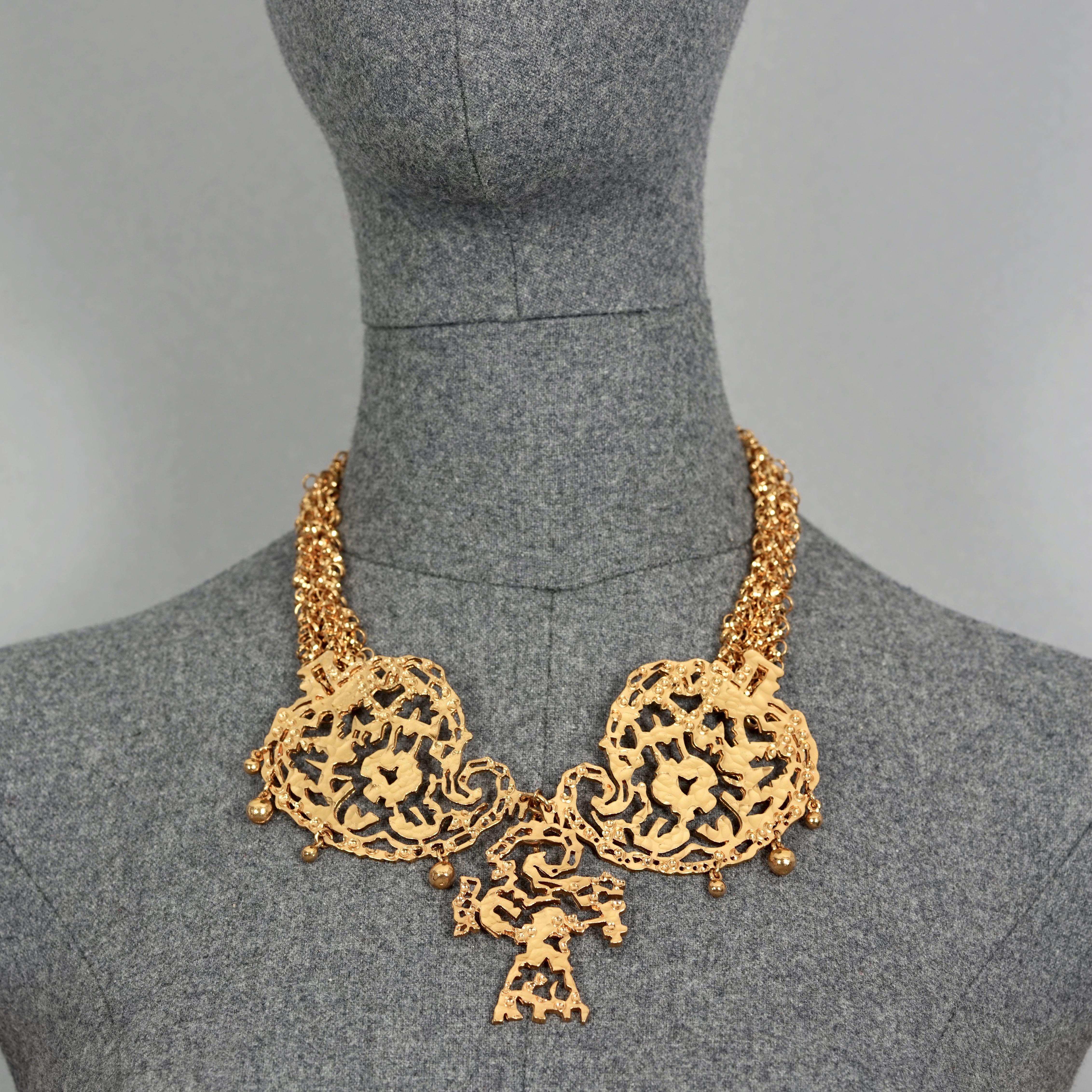Vintage CHRISTIAN LACROIX Opulent Filigree Multi Chain Necklace

Measurements:
Height : 4.33 inches (11 cm)
Wearable Length: 19.29 inches (49 cm) to 21.65 inches (55 cm) adjustable

Features:
- 100% Authentic CHRISTIAN LACROIX.
- Hammered openwork/