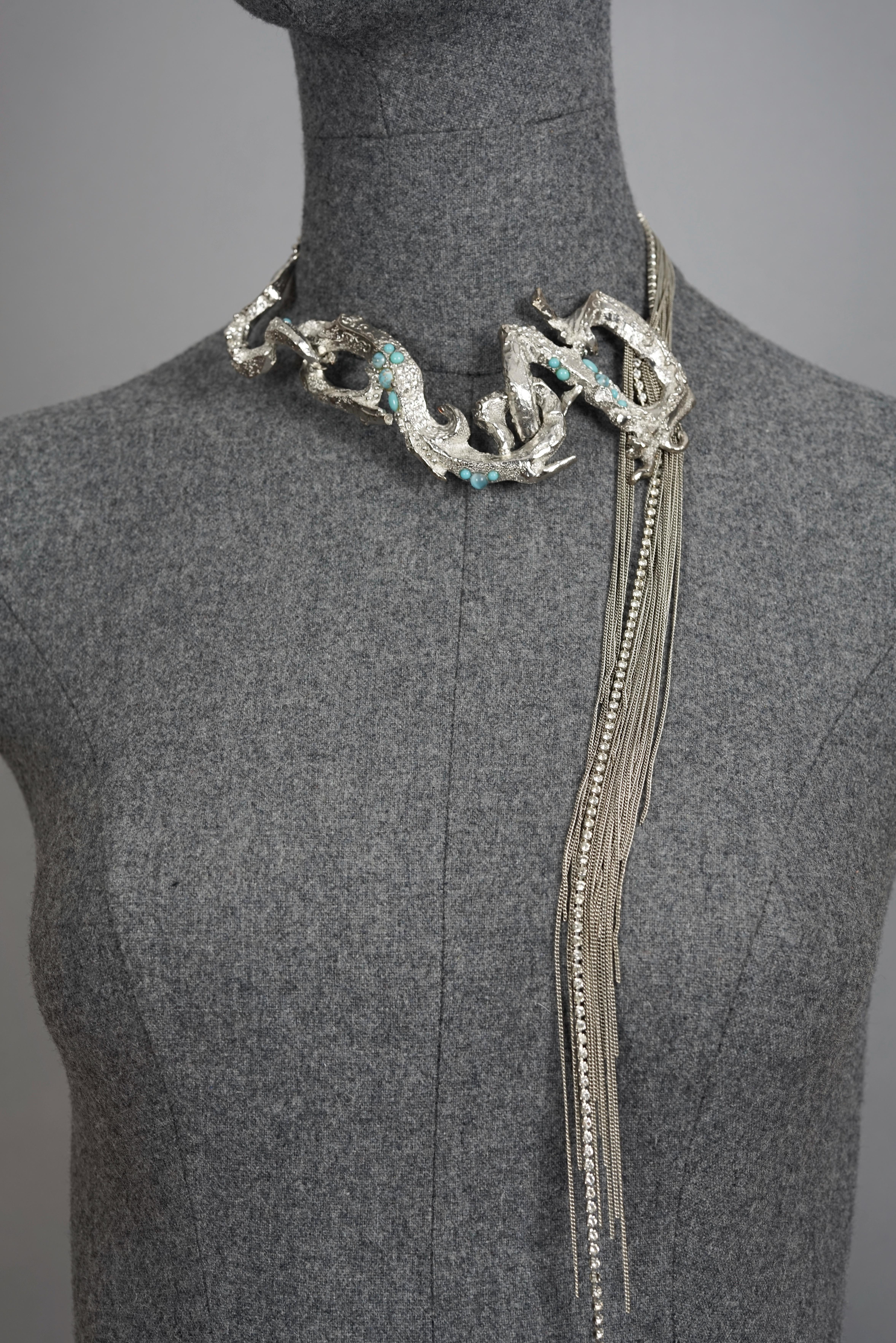 Vintage CHRISTIAN LACROIX Opulent Rigid Cascading Multi Chain Choker Necklace

Measurements:
Height: 2.56 inches (6.5 cm)
Wearable Length: 13.97 inches (35.5 cm), 14.76 inches (37.5 cm) and 15.74 inches (40 cm)

Features:
- 100% Authentic CHRISTIAN