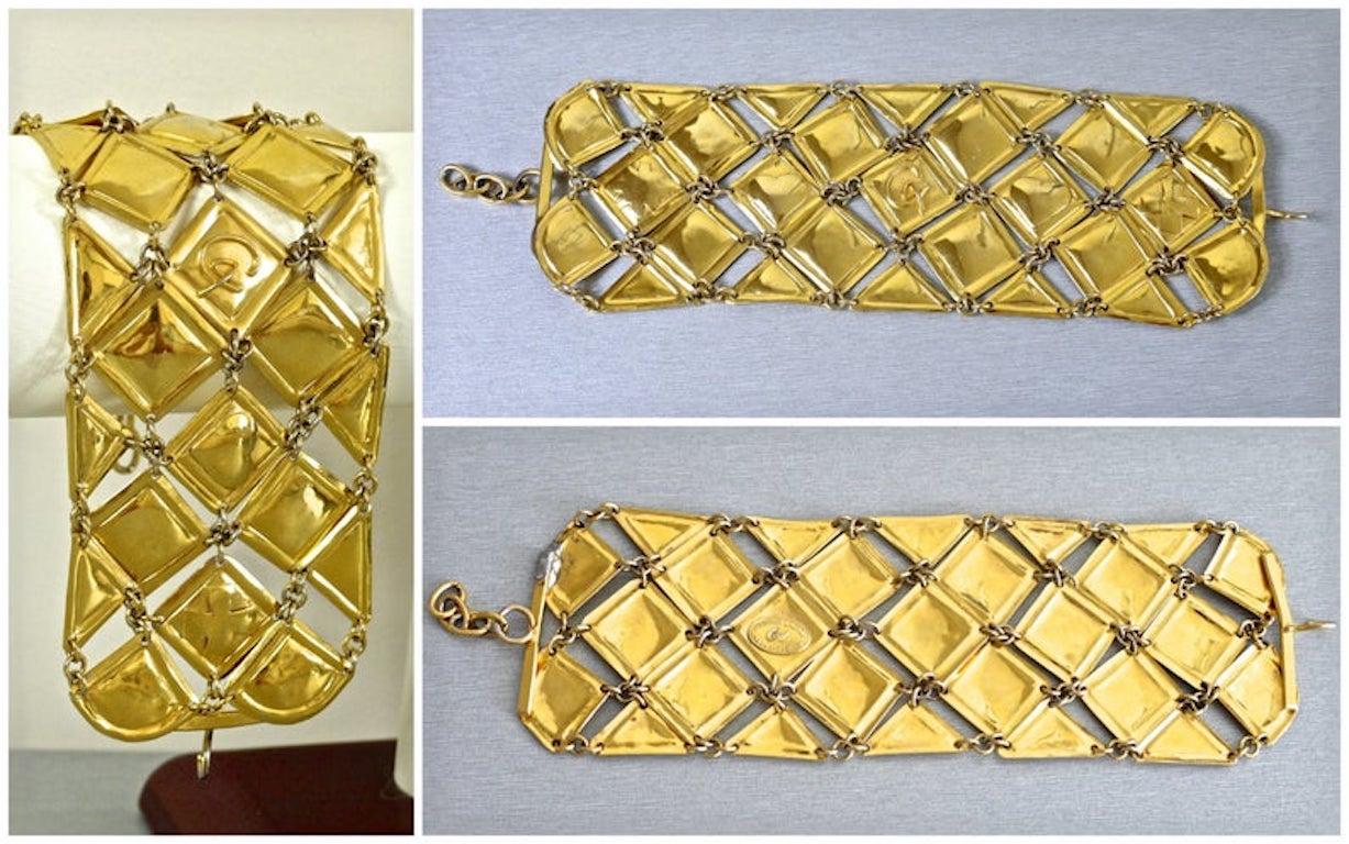 Vintage CHRISTIAN LACROIX Wide Mesh Bracelet

Measurements:
Length: 7 inches (without the hook and chain closure)
Height: 2.5 inches

Features:
- 100% Authentic Christian Lacroix.
- Articulated wide bracelet in gold tone.
- Inverted square plates