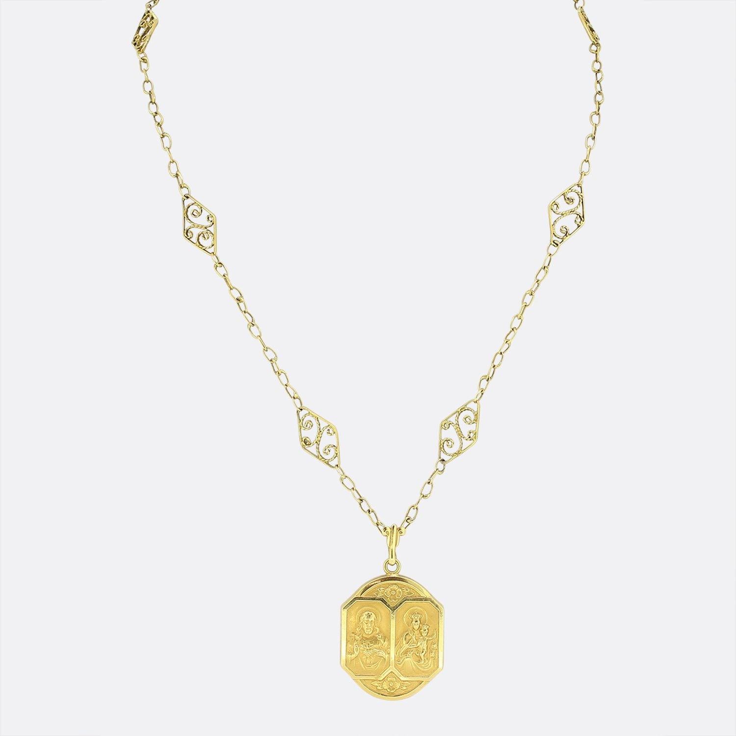 This is a wonderfully crafted vintage 18ct yellow gold necklace. The pendant features two separately bordered portraits; one representing the Holy Sacred heart of Jesus Christ and the other featuring our lady of Scapular with a plain unembellished