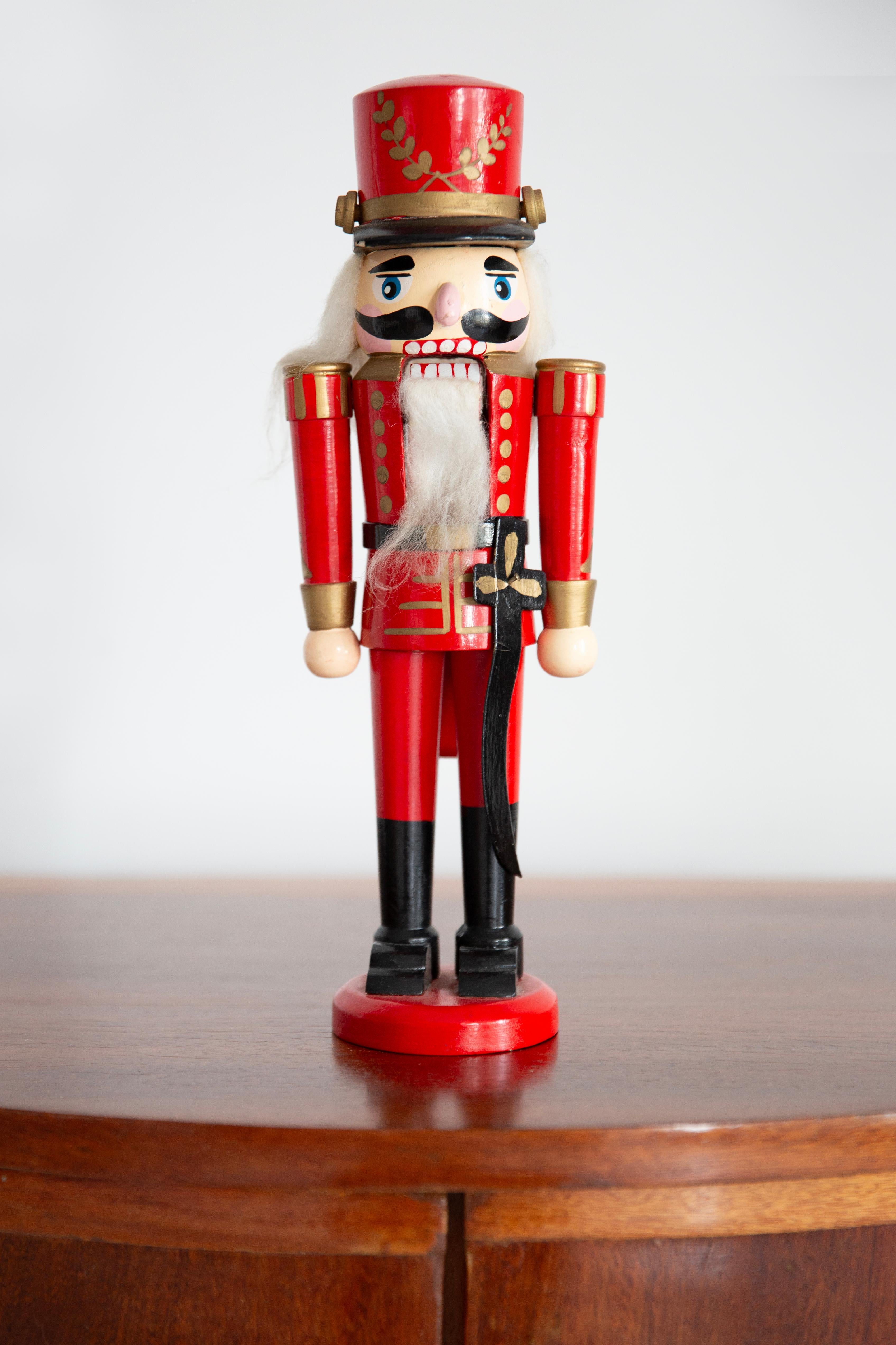 Wooden nutcracker figure from the Erzgebirge. The region Erzgebirge formerly Eastern Germany is famous for this special kind of nutcrackers, where intricate carving has been their home. Completely hand-painted in bright colors and decorated with