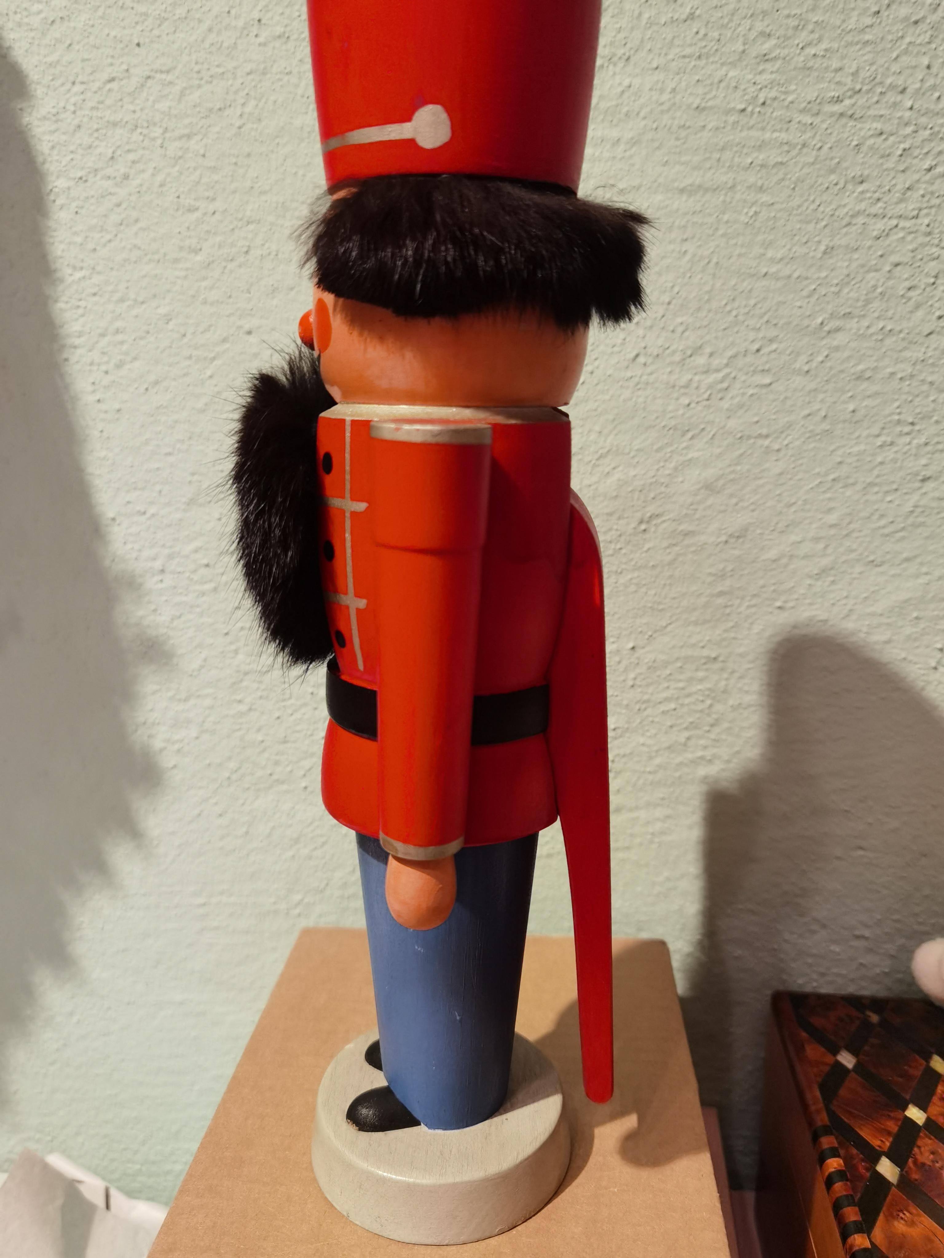 Vintage wooden nutcracker figure from the Erzgebirge. The region Erzgebirge formerly Eastern Germany is famous for this special kind of nutcrackers, where intricate carving has been their home. Completely hand-painted in red and blue colors and