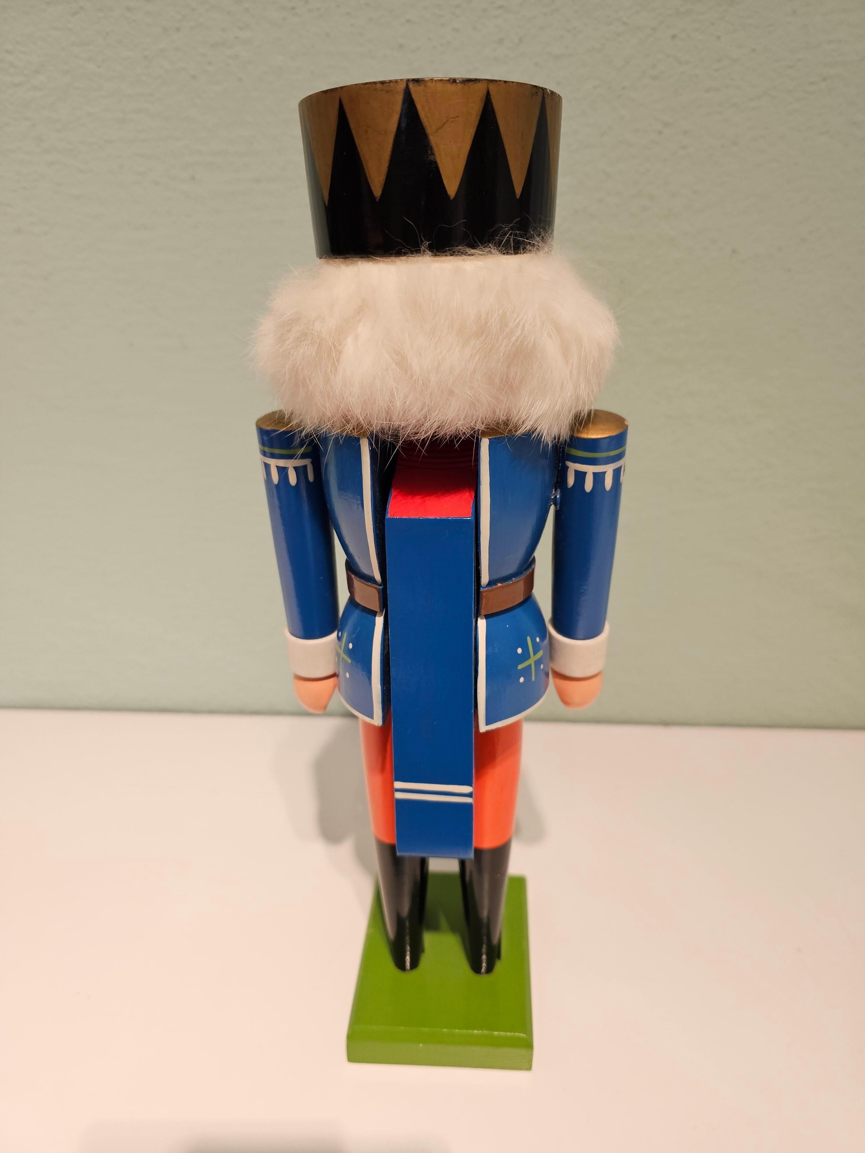 Vintage wooden nutcracker figure from the Erzgebirge. The region Erzgebirge formerly Eastern Germany is famous for this special kind of nutcrackers, where intricate carving has been their home. Completely hand-painted in red and blue colors and
