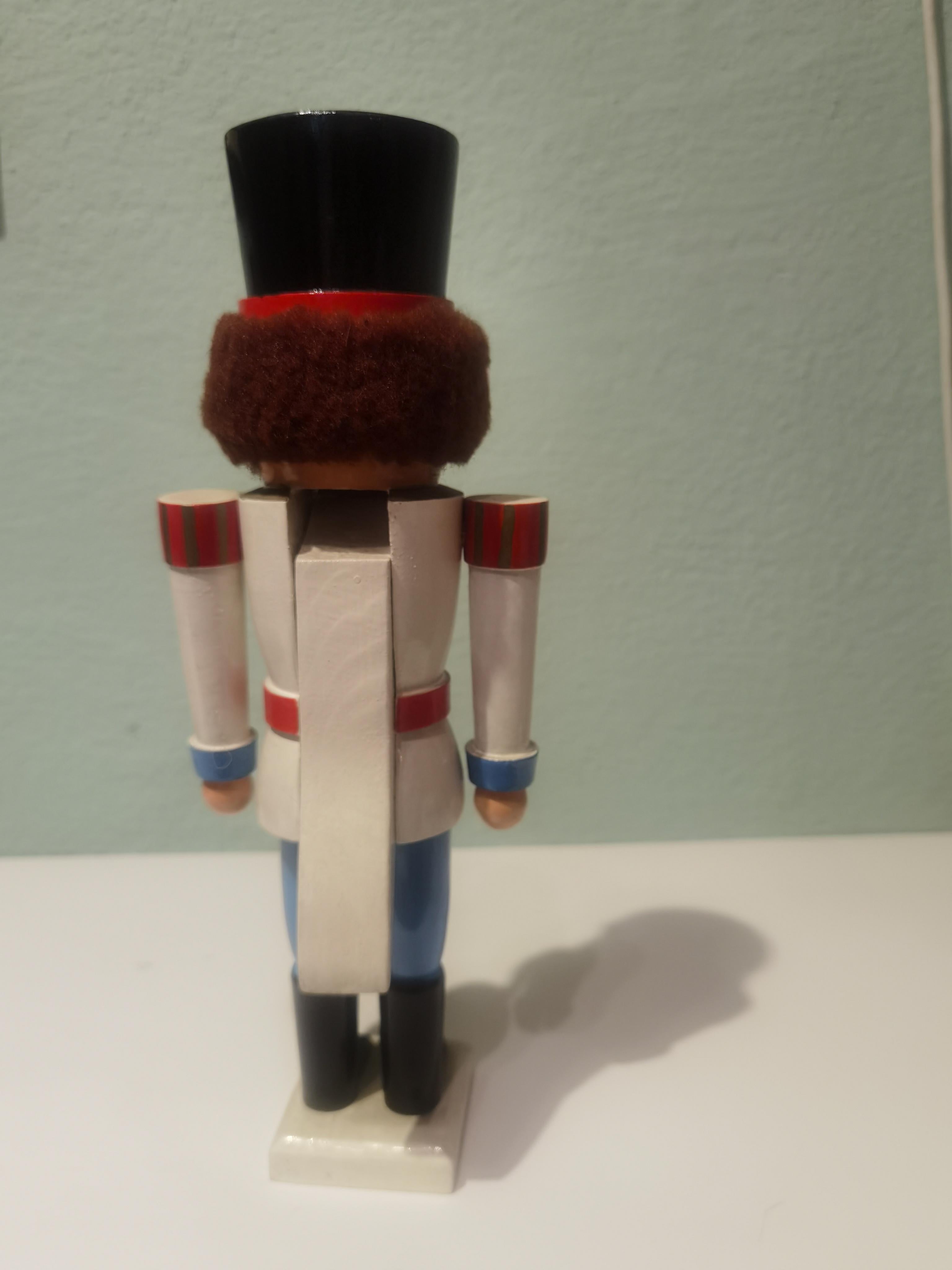 Vintage wooden nutcracker figure from the Erzgebirge. The region Erzgebirge formerly Eastern Germany is famous for this special kind of nutcrackers, where intricate carving has been their home. Completely hand-painted in blue and white colors and