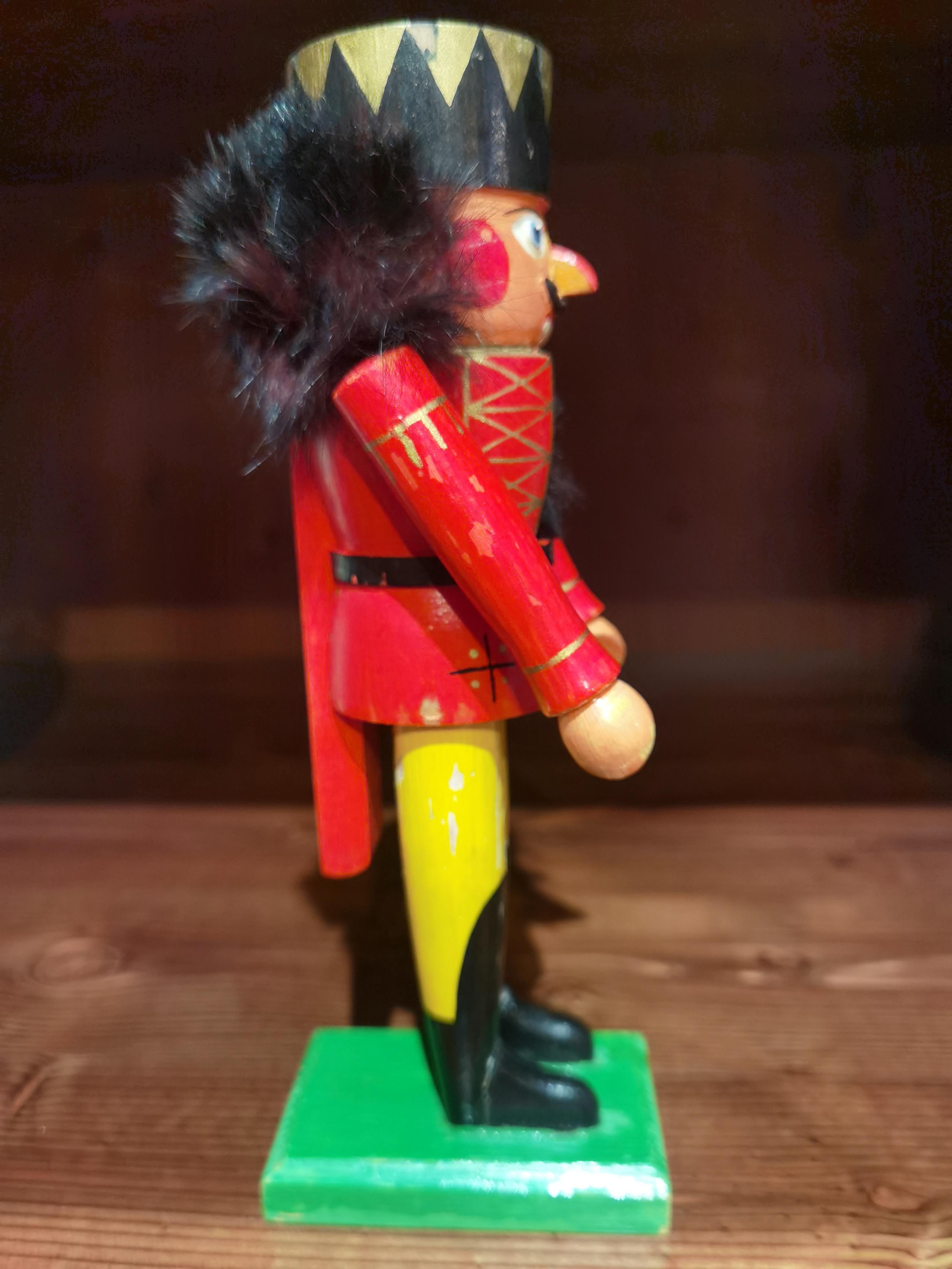 Vintage wooden nutcracker figure from the Erzgebirge. The region Erzgebirge formerly Eastern Germany is famous for this special kind of nutcrackers, where intricate carving has been their home. Completely hand-painted in bright colors and decorated