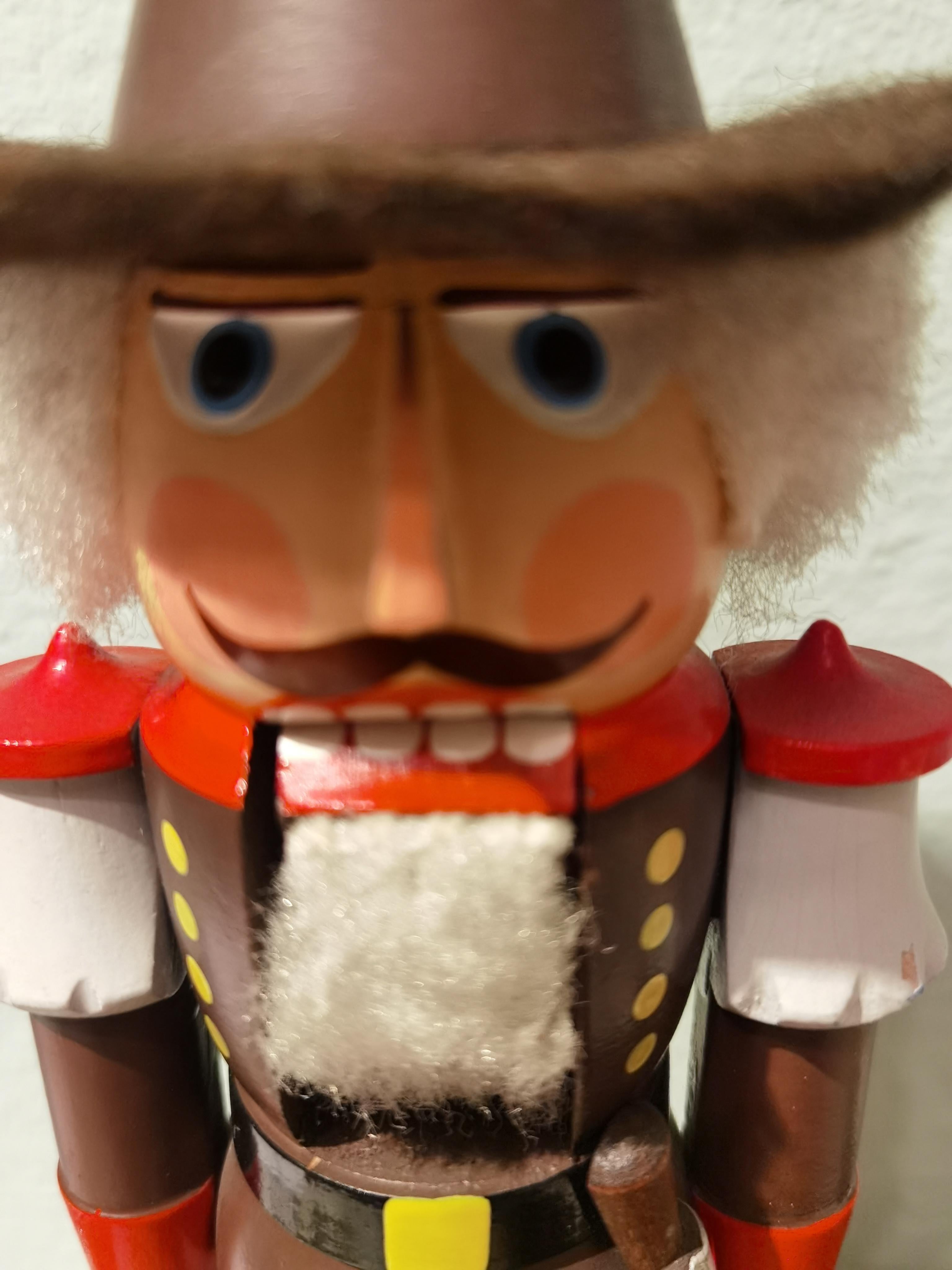 Wooden nutcracker Tiroler figure from the Erzgebirge. The region Erzgebirge formerly Eastern Germany is famous for this special kind of nutcrackers, where intricate carving has been their home. Completely hand-painted in brown and red colors and