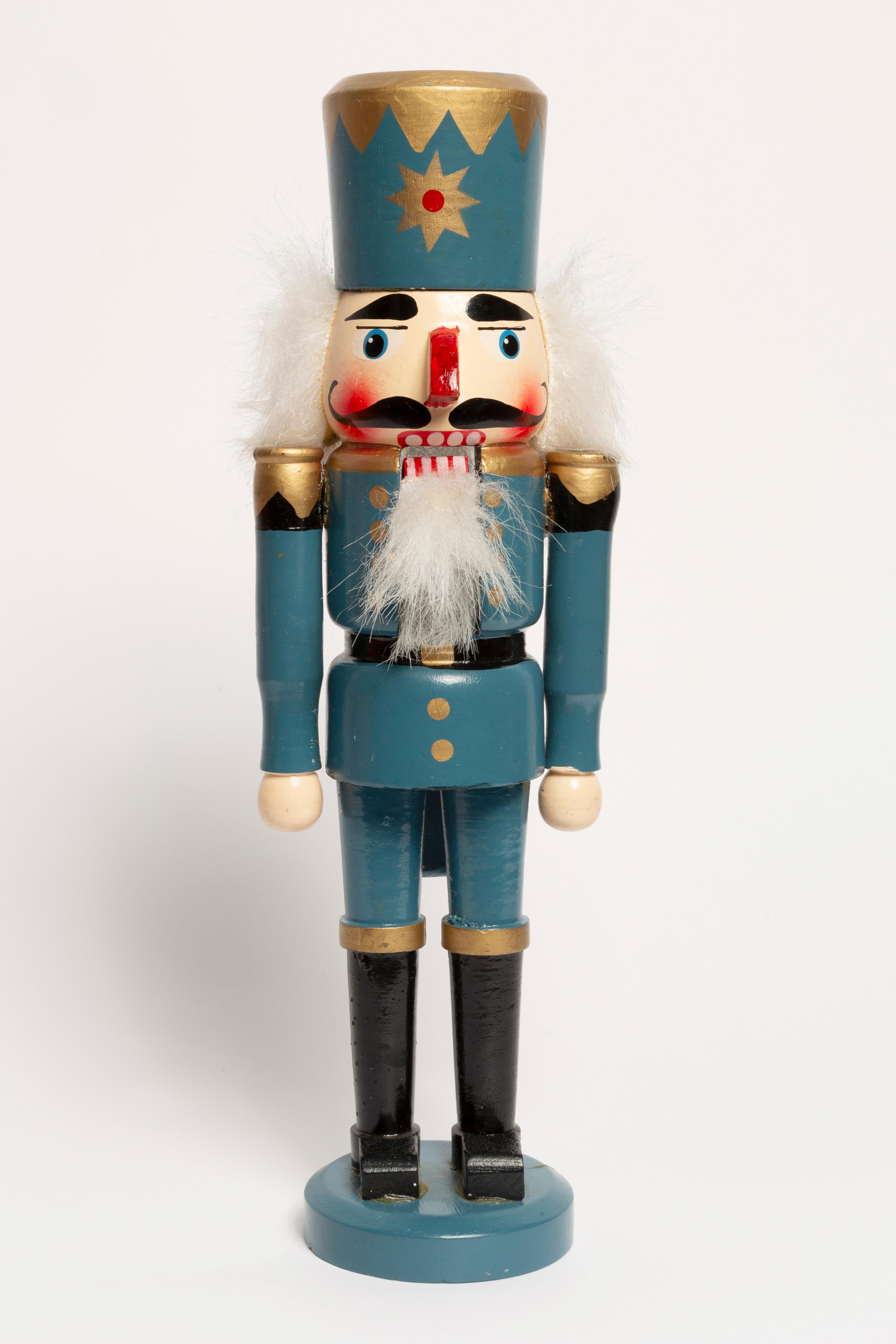 Small wooden nutcracker figure from the Erzgebirge. The region Erzgebirge formerly Eastern Germany is famous for this special kind of nutcrackers, where intricate carving has been their home. Completely hand-painted in bright colors and decorated