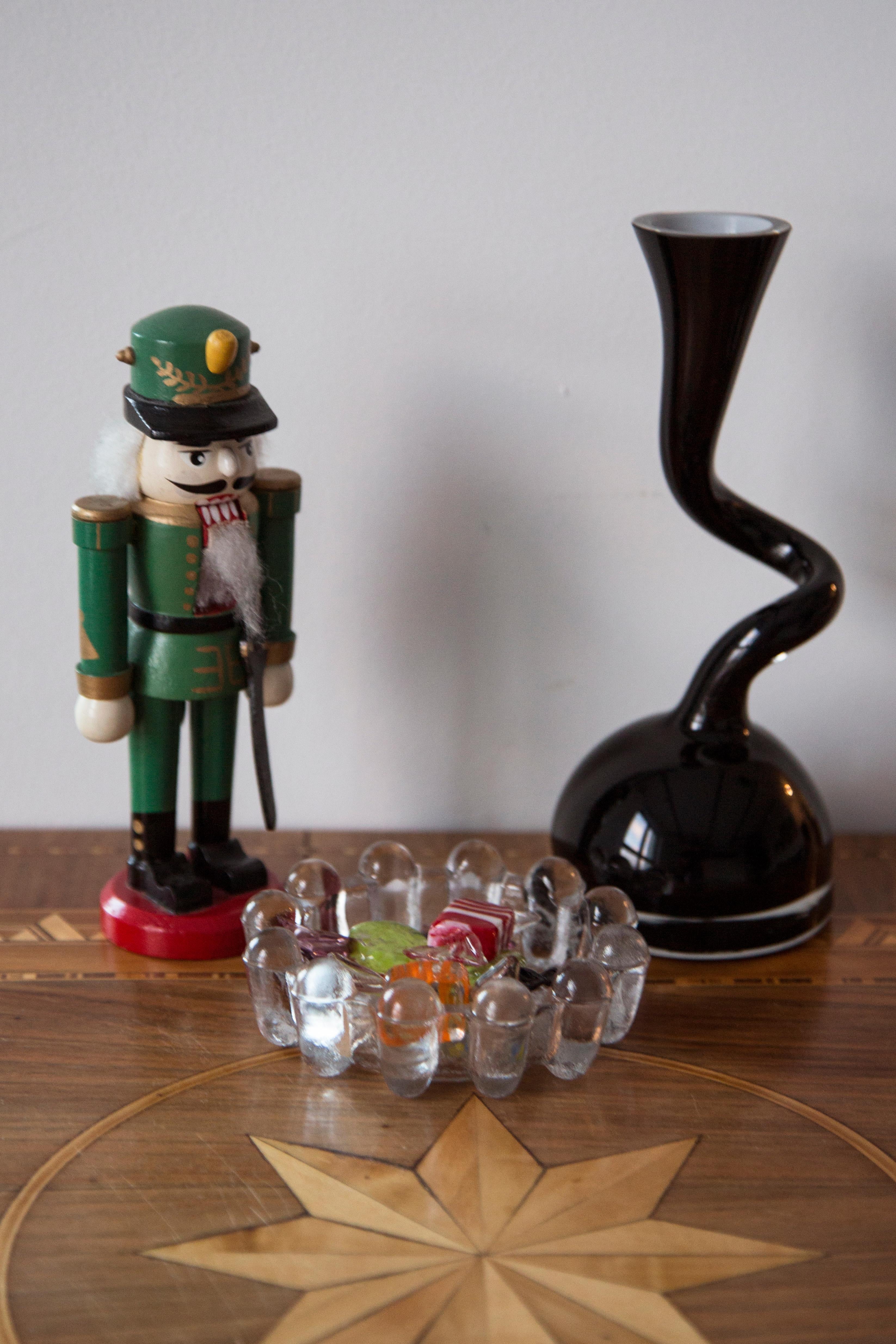 Wooden nutcracker figure from the Erzgebirge. The region Erzgebirge formerly Eastern Germany is famous for this special kind of nutcrackers, where intricate carving has been their home. Completely hand-painted in bright colors and decorated with