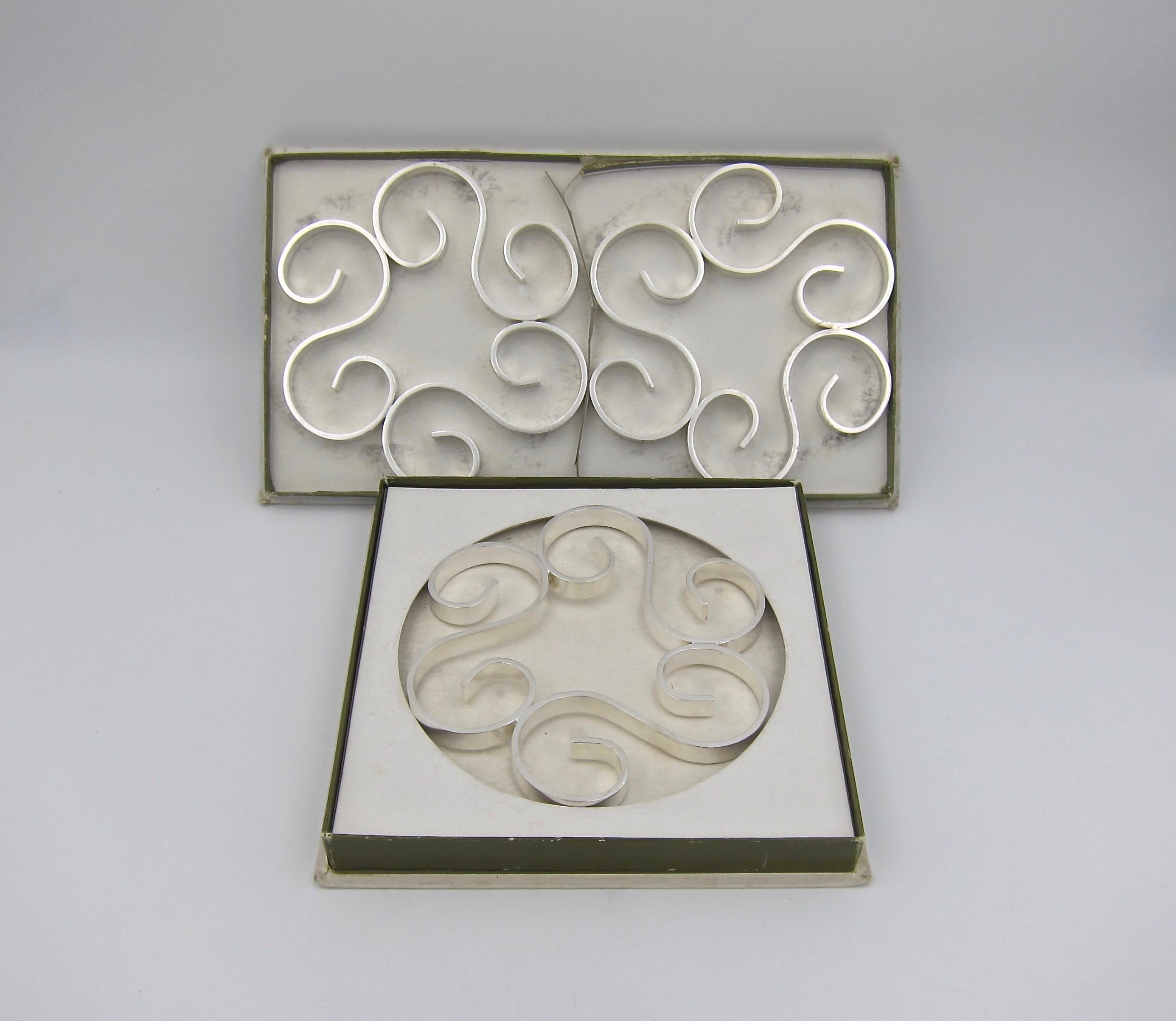 A vintage set of three Christofle Gallia trivets from the company's line of silvered Gallia metal luxury goods designed in France during the Art Deco period. Each 