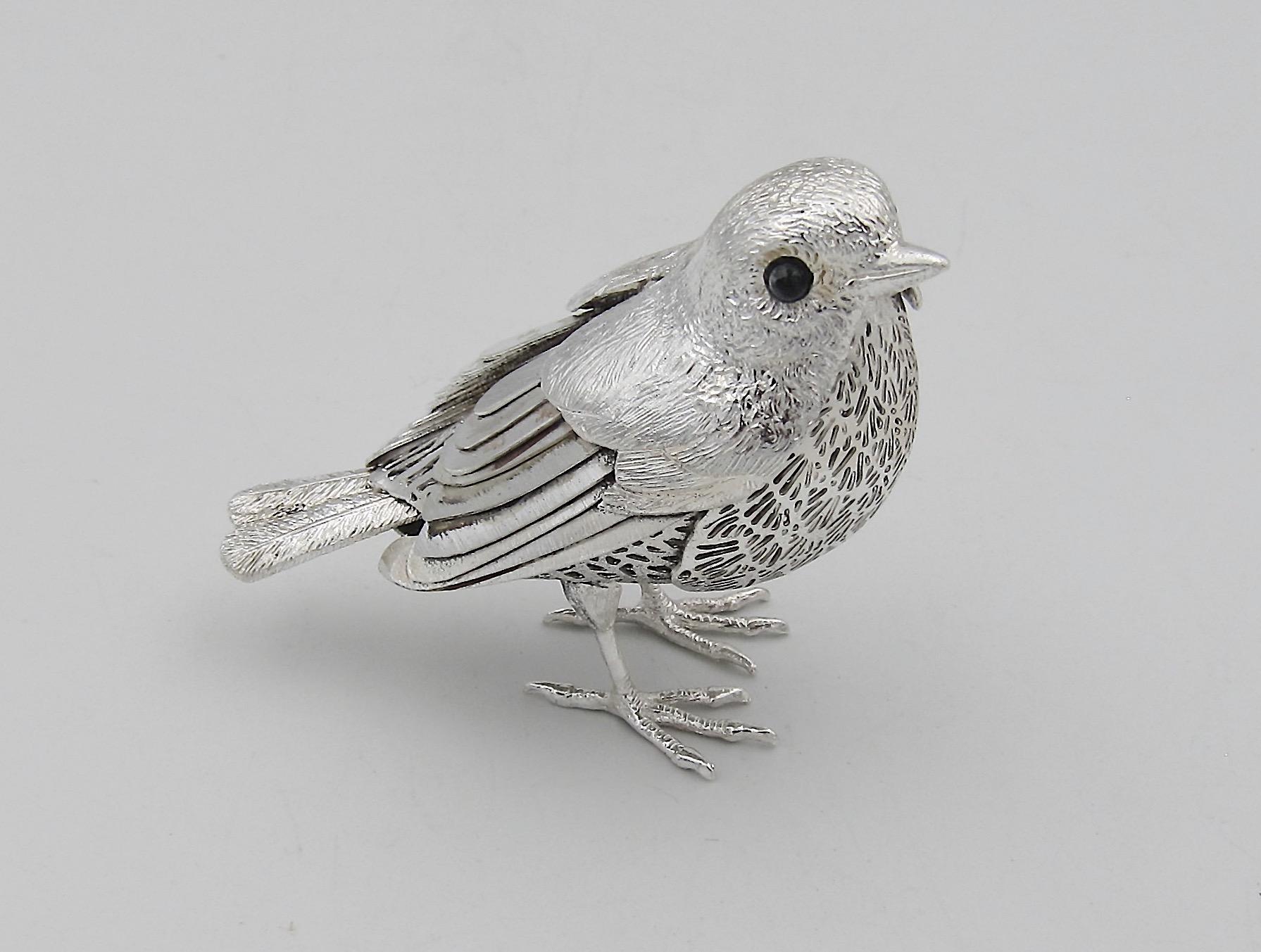 A vintage silver-plated bird figurine from the Christofle of Paris Lumière d'Argent or Silver Light Collection. The bird is likely a robin with a delicate openwork body of silver metal, textured feathers, and inset eyes of black onyx. The bird bears