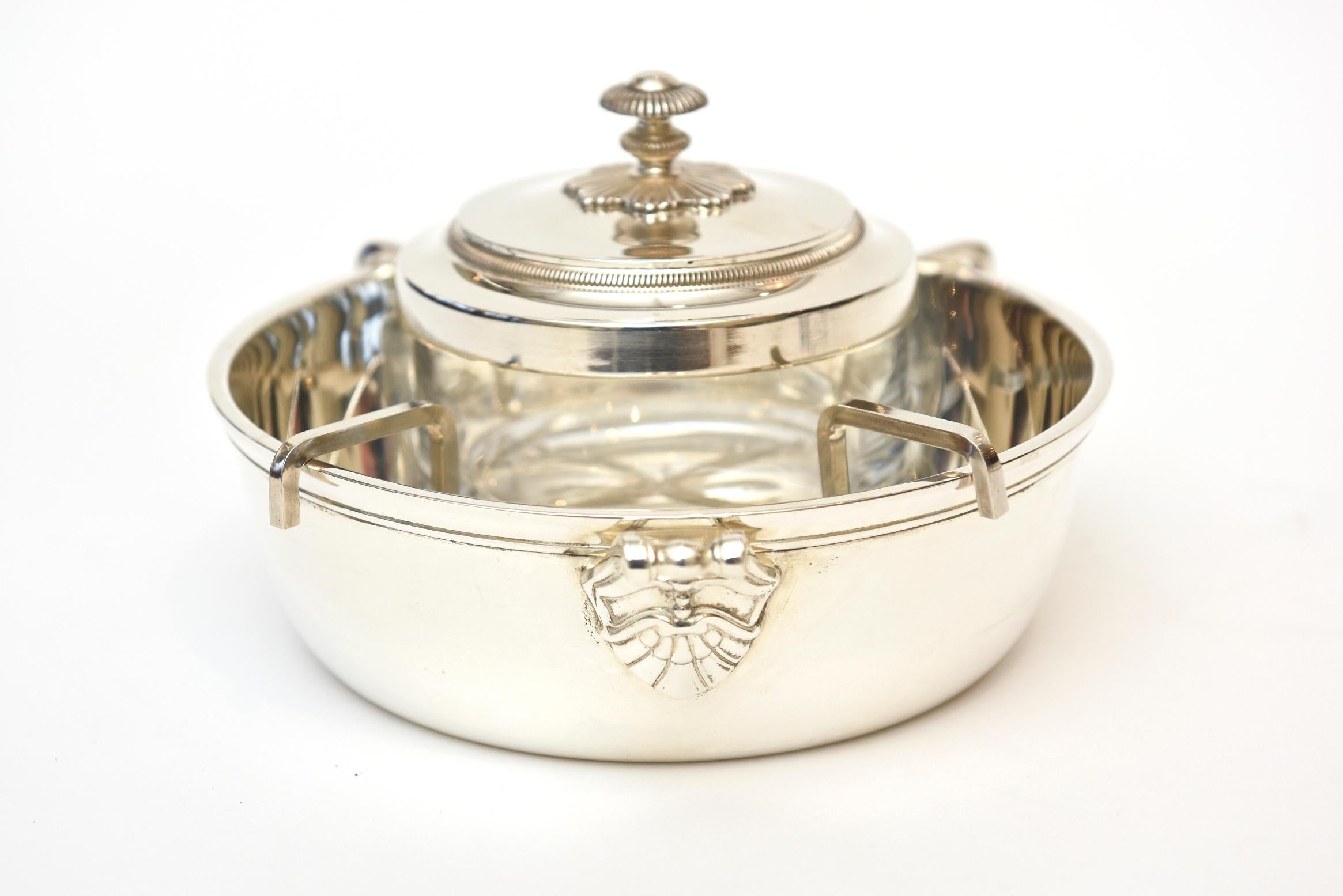This lovely and substantial size vintage Christofle caviar serving bowl is silver plate with a glass insert. It has semi traditional patterns on it for a modern caviar bowl from the 1980s. It is elegant and refined and such a perfect caviar serving