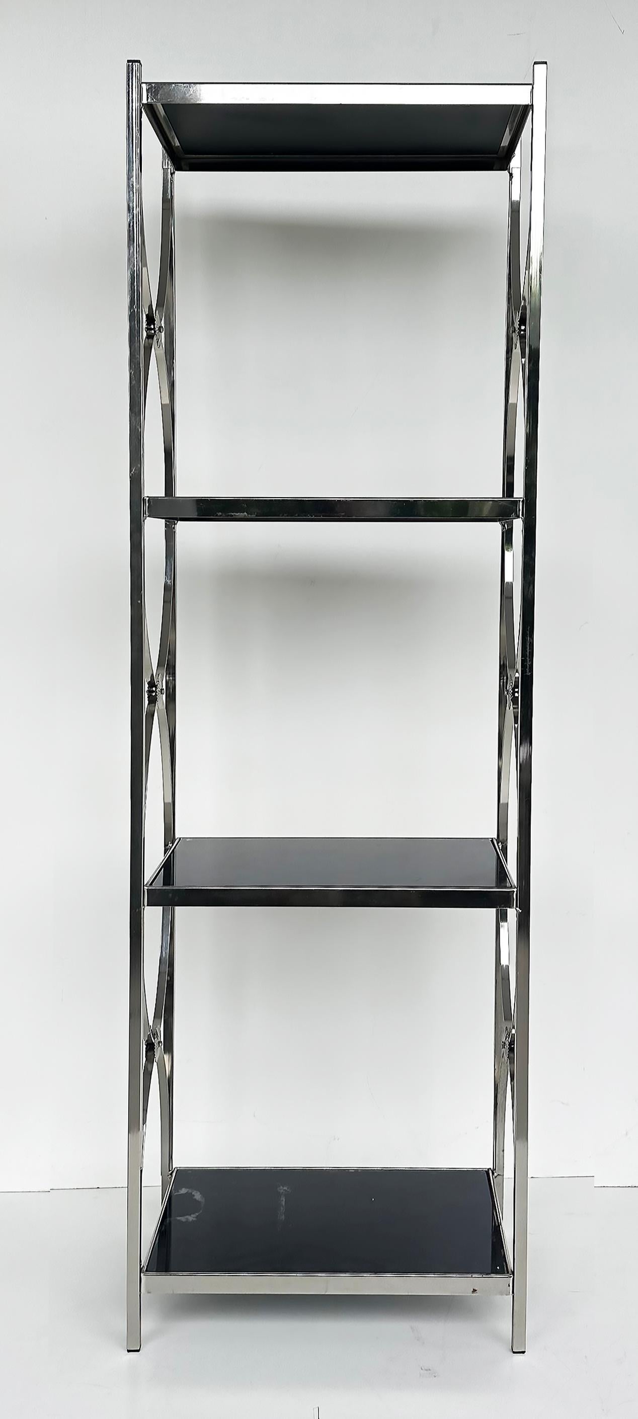 Vintage Chrome 3-Tiered Black Glass Shelves Etagere, A Pair

Offered for sale is a pair of late 20th-century vintage chrome framed etageres with glass shelves. The chrome curves and is met with rosettes on the sides. The etageres are 3-tiered and