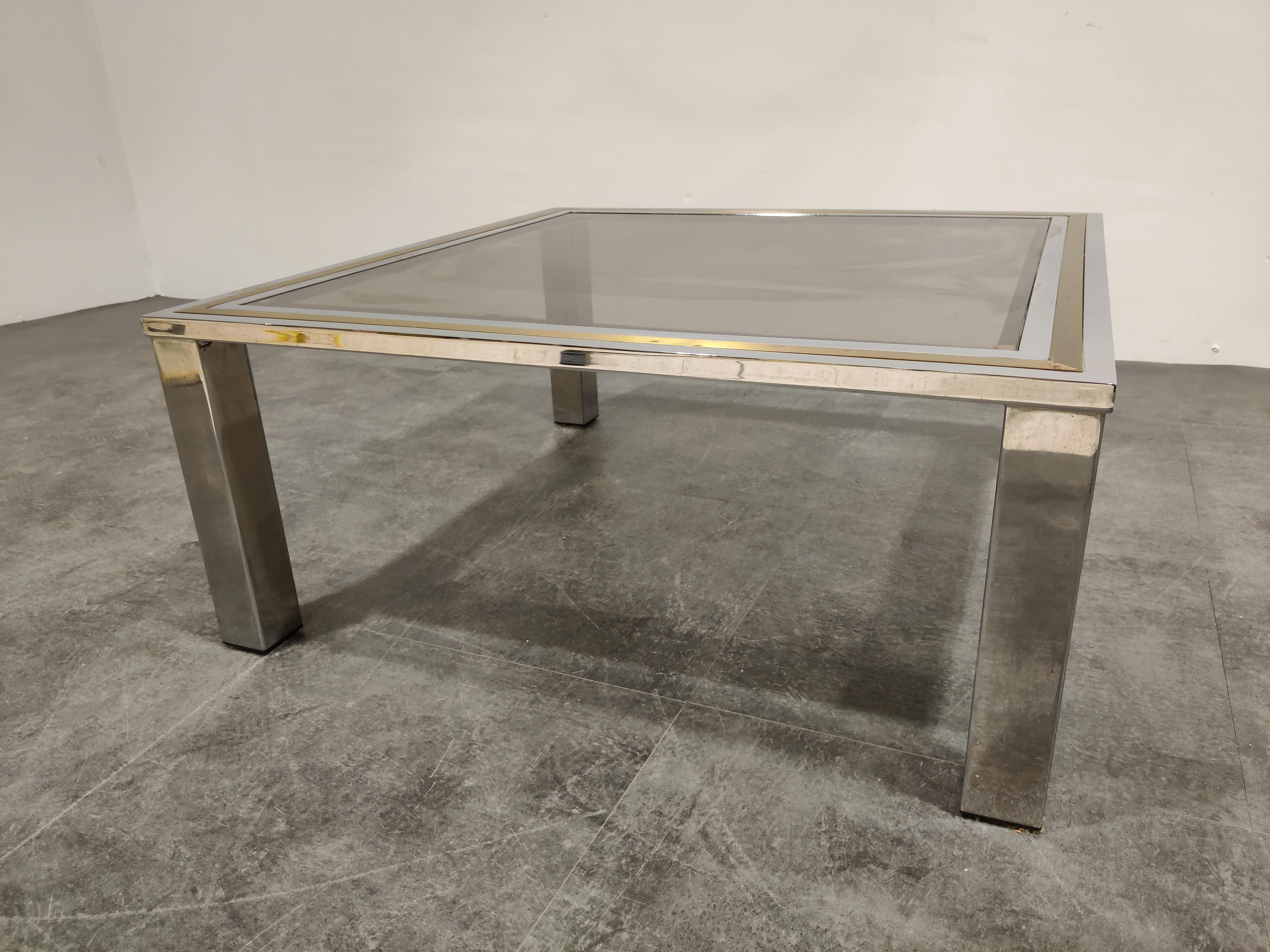 Chrome and brass coffee table with a smoked glass top in the style of Willy Rizzo or Romeo Rega

Hollywood regency style.

Condition: Patina on the brass/chrome, original glass top with minor scratches,

1970s, Belgium

Dimensions:
Height
