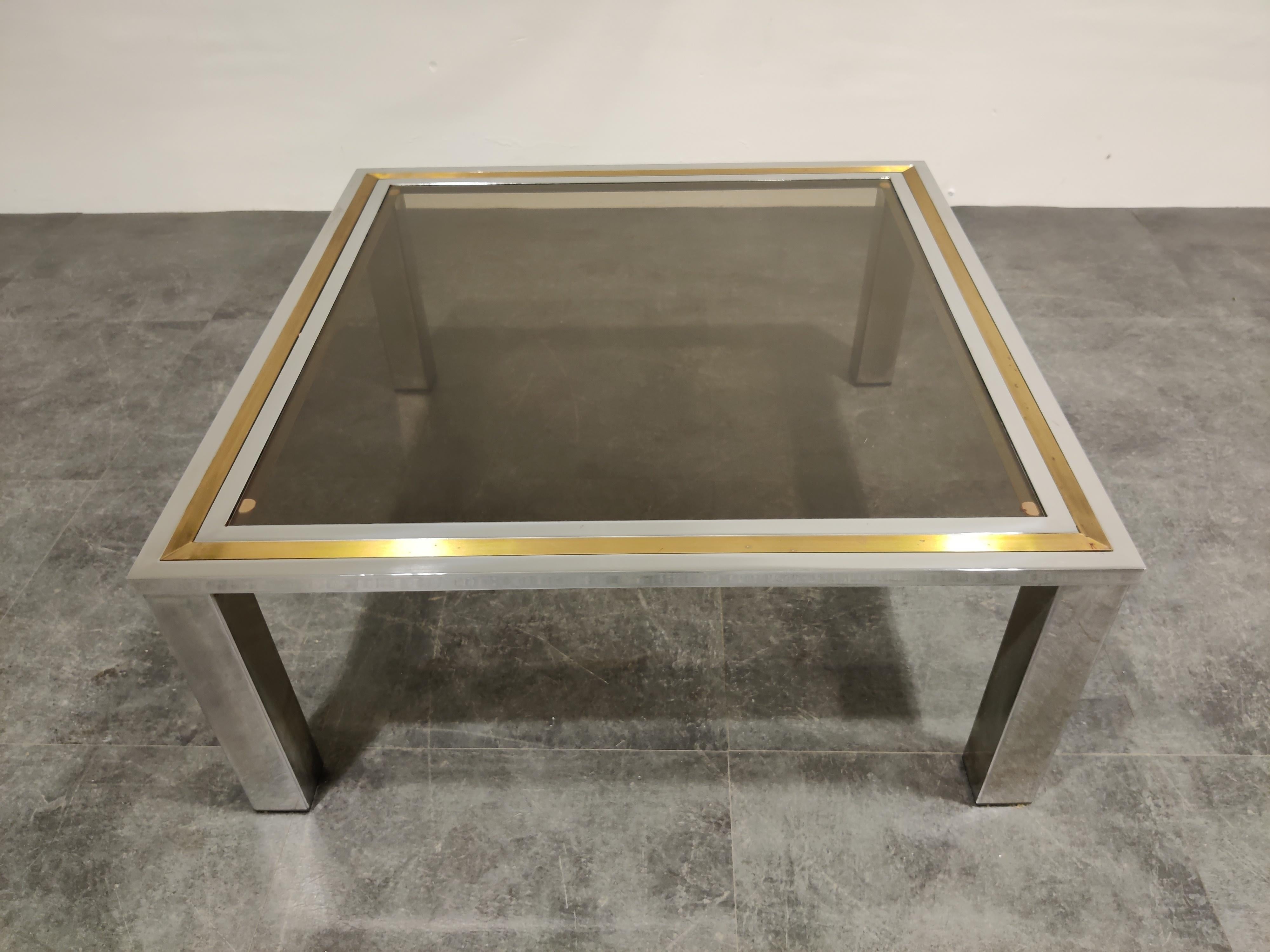Chrome and brass coffee table with a smoked glass top in the style of Willy Rizzo or Romeo Rega

Hollywood regency style.

Condition: Patina on the brass/chrome, original glass top with minor scratches,

1970s, Belgium

Dimensions:
Height