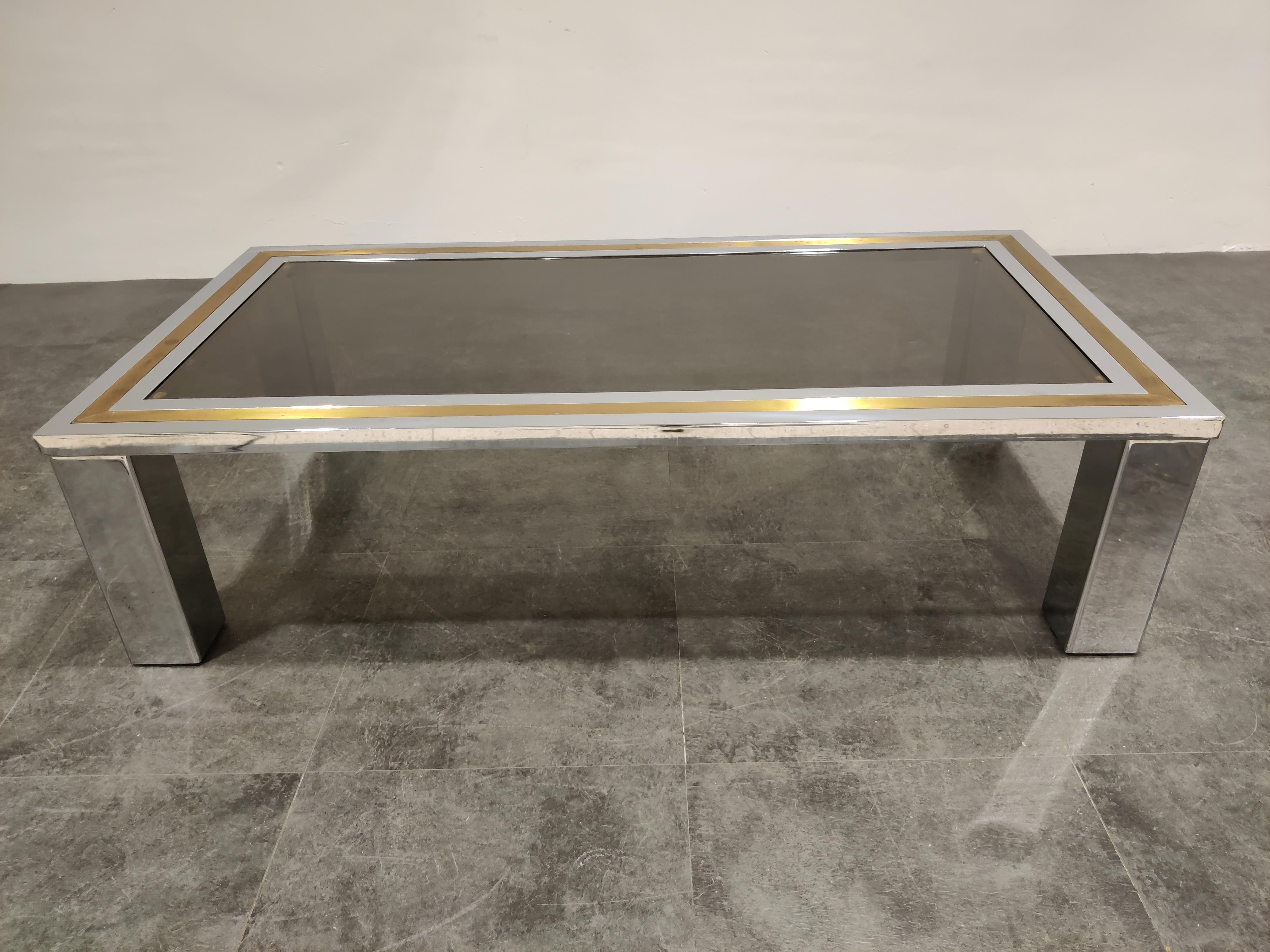 Chrome and brass coffee table with a smoked glass top in the style of Willy Rizzo or Romeo Rega

Hollywood regency style.

Condition: Patina on the brass/chrome, original glass top with minor scratches,

1970s, Belgium

Dimensions:
Height
