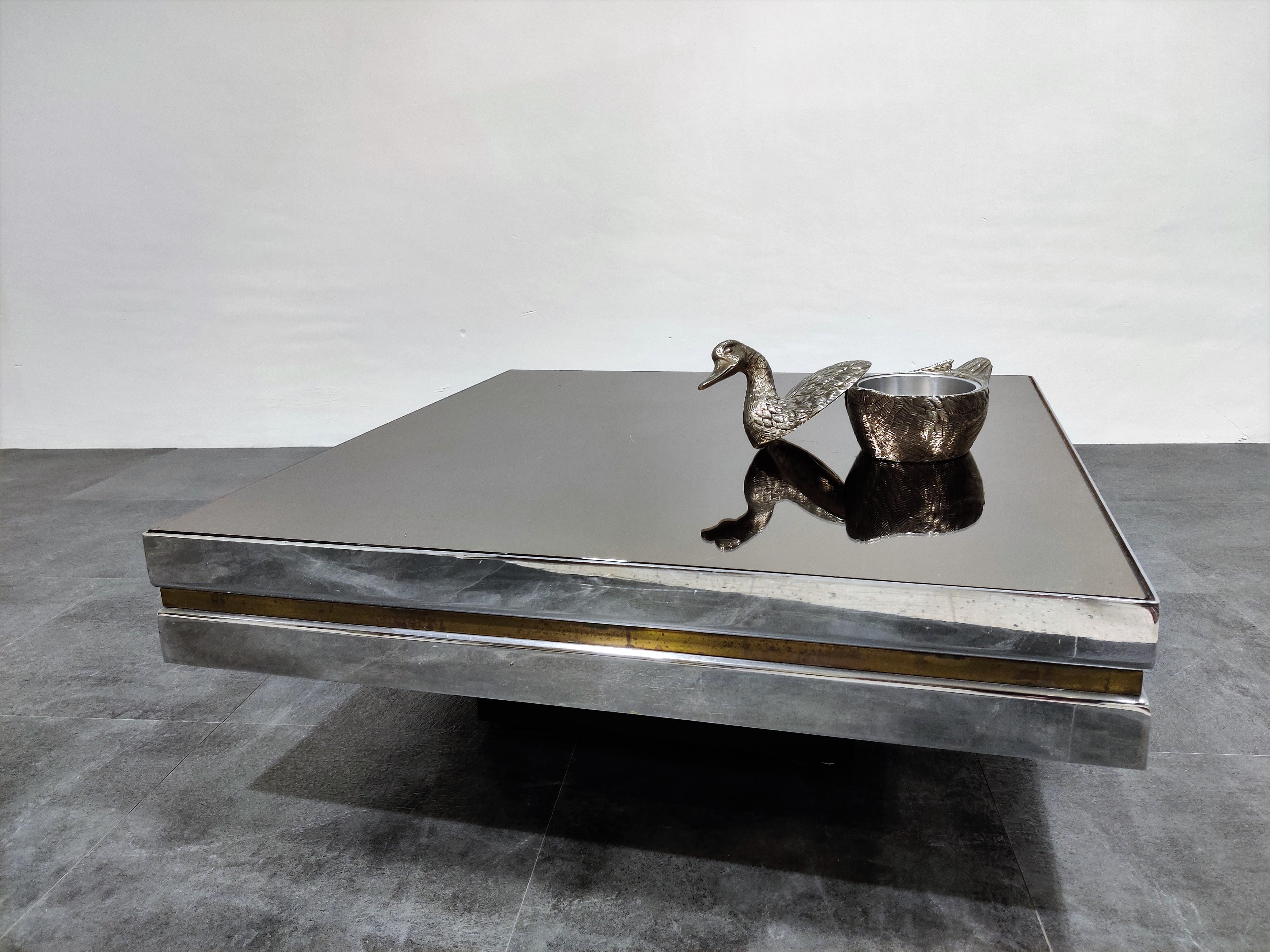 Chrome and brass coffee table with a mirrored glass top in the style of Willy Rizzo or Romeo Rega

Hollywood regency style.

Condition: Patina on the brass/chrome, original glass top with minor scratches

1970s - Belgium

Dimensions:
Height