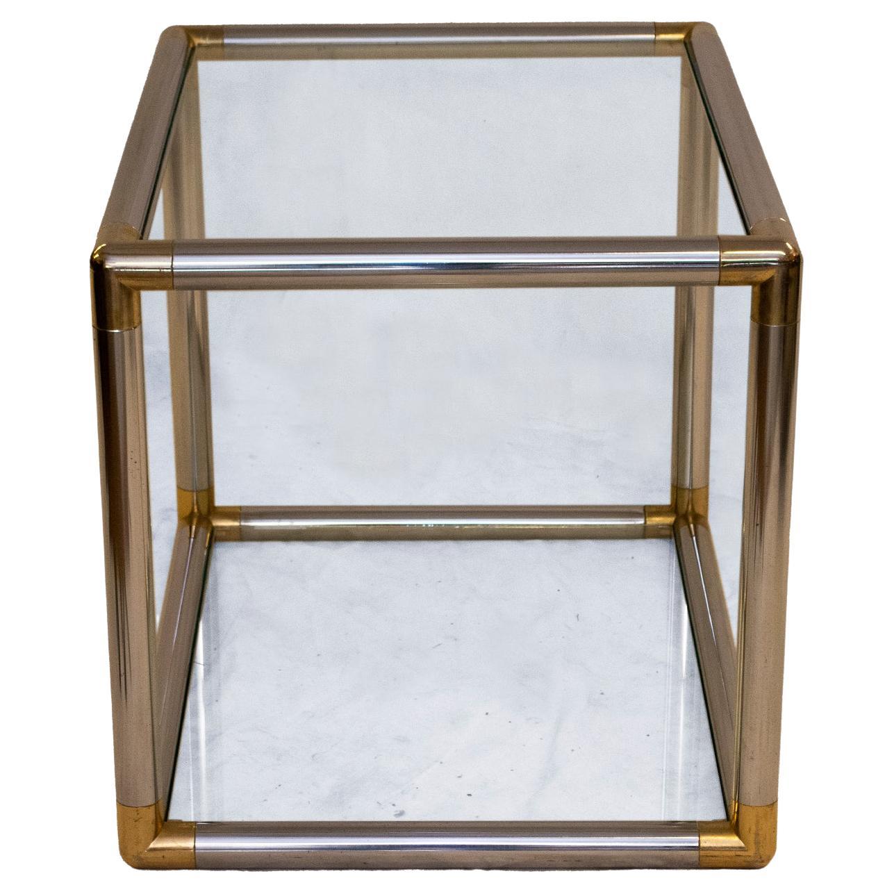 Unique End Table in the style of Karl Springer, renowned designer and manufacturer of luxury furniture. Polished chrome with brass details at curved corners. This end table is glamorous as well as practical with two glass inserts, top and bottom.