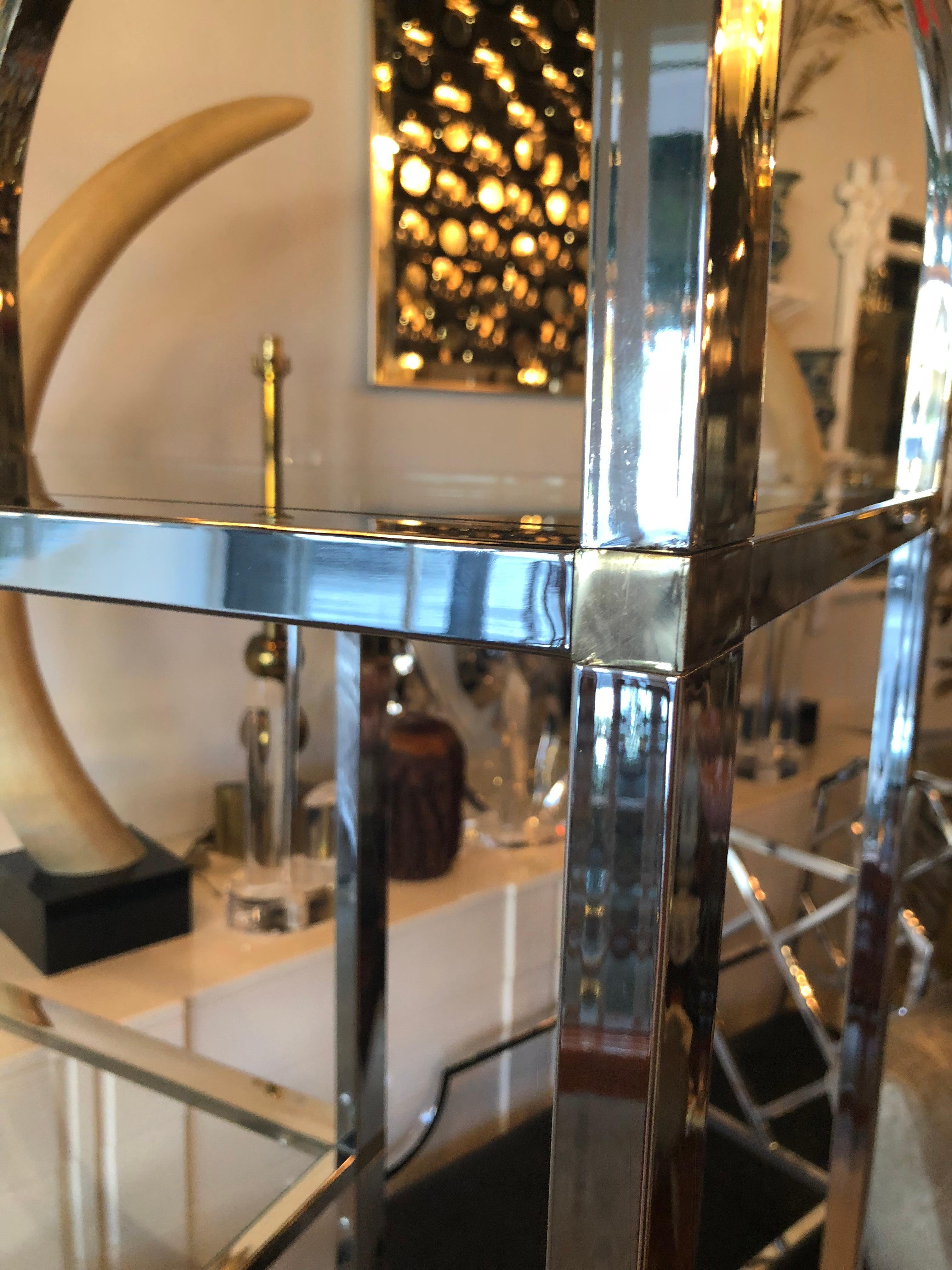 Vintage arched chrome with brass accents display shelf shelves etageres . Chrome has been polished. Glass is new with the exception of the original dark colored glass bottom shelves. In the style of Milo Baughman.
 