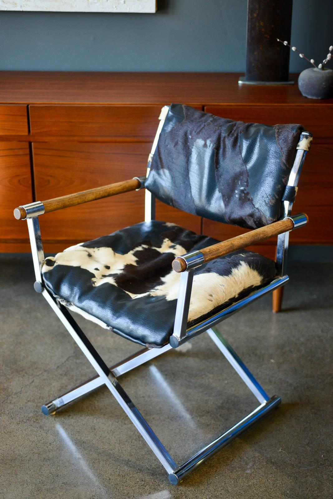 Vintage chrome and cowhide directors chair, ca. 1970. Beautiful cowhide leather with oak armrests. Chrome has been polished with only slight wear and leather has beautiful soft worn patina. Very good original condition.

Measures 23