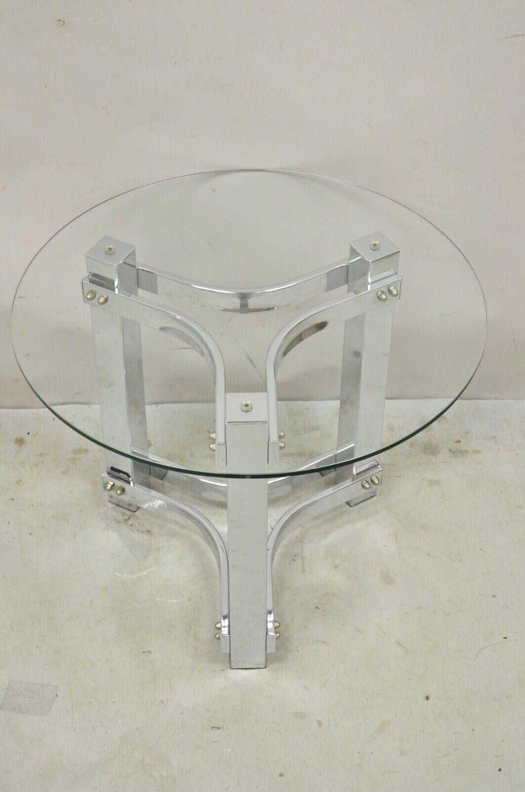 Vintage Chrome and Glass Mid Century Modern Space Age Round Accent Side Table. Item features a space age chrome metal base, round glass top, great style and form. Circa 1970s. Measurements: 19.75
