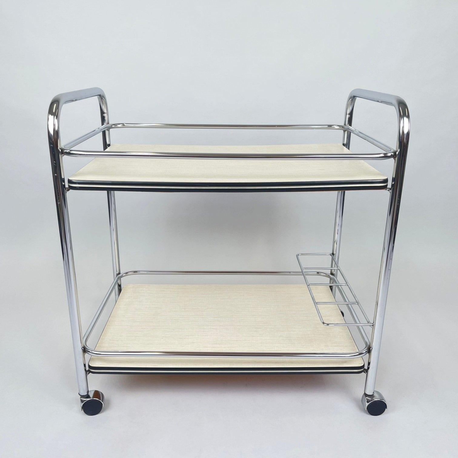 Vintage serving trolley made of chrome and plywood. 
Very good vintage condition with some signs of use (see photo).