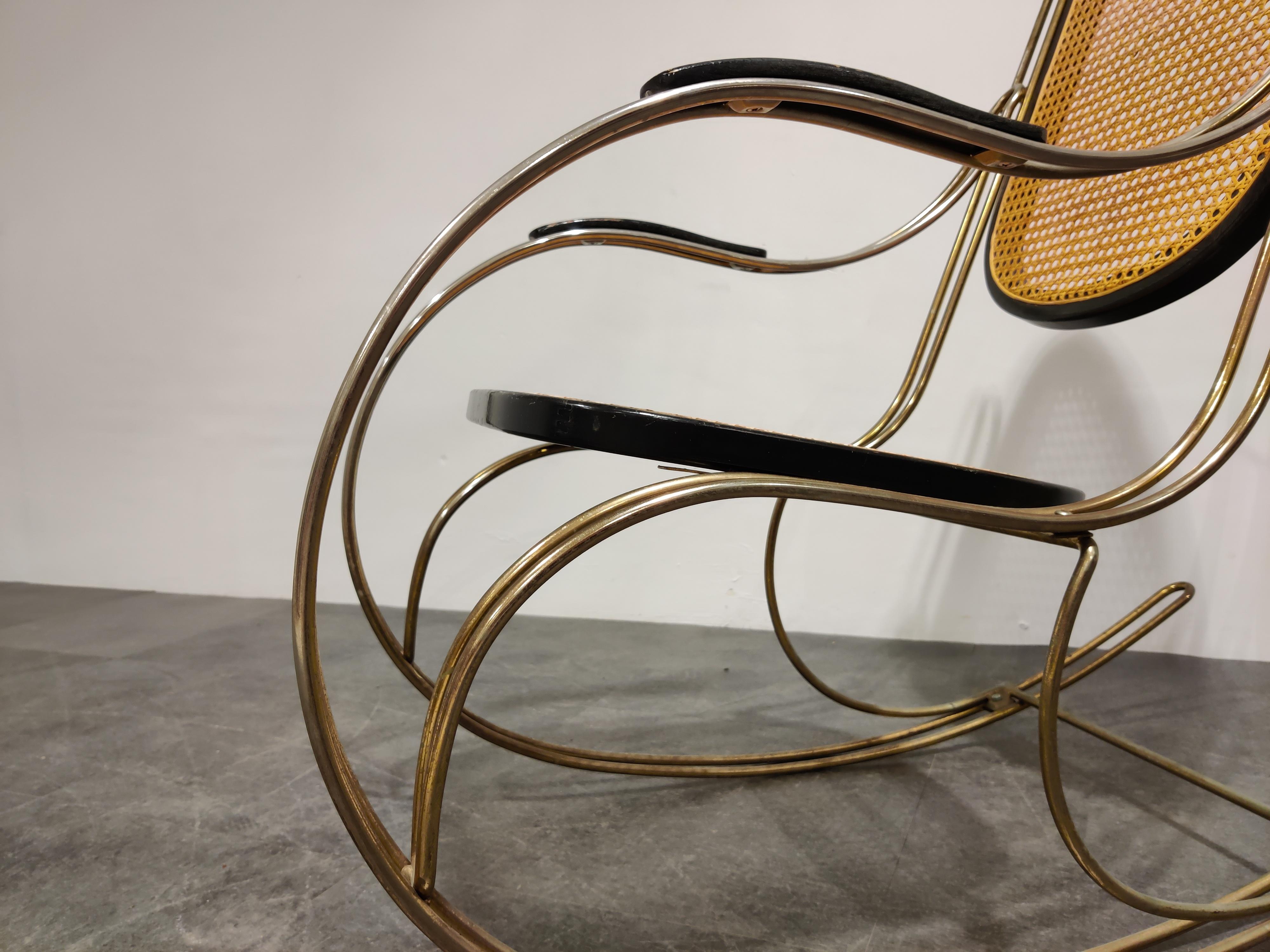 Midcentury rocking chair made from chromed metal, rattan woven seats and backrest and lacquered wood.

This timeless piece has just the right amount of patina and looks beautiful in any interior.

Good condition,

1960s, Italy

Measures: