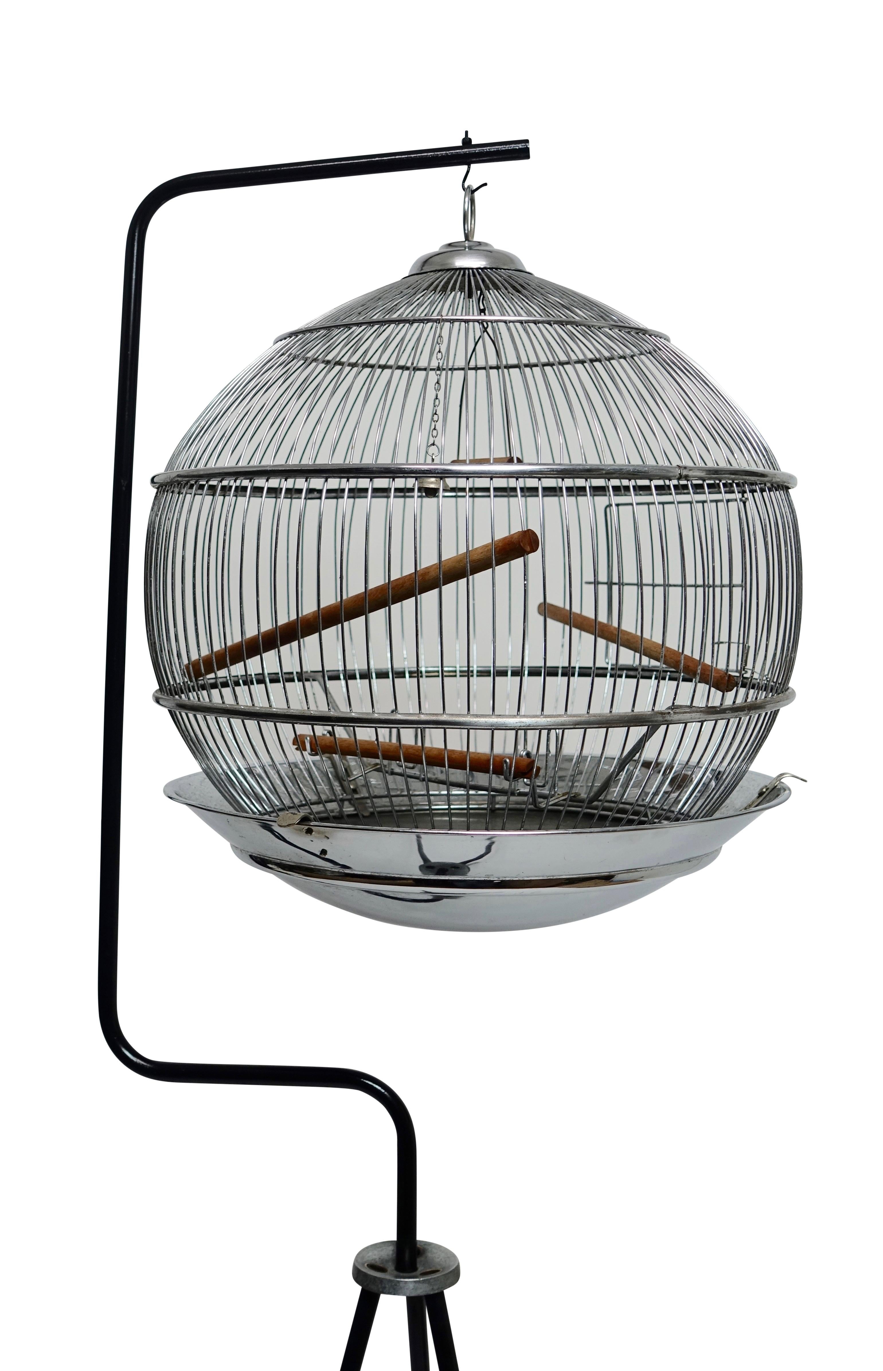 Sweet ball shape chrome birdcage suspended on an iron tripod base, American, circa 1950.
Measures: Bird cage height - 20 inches x diameter-15.5 inches.