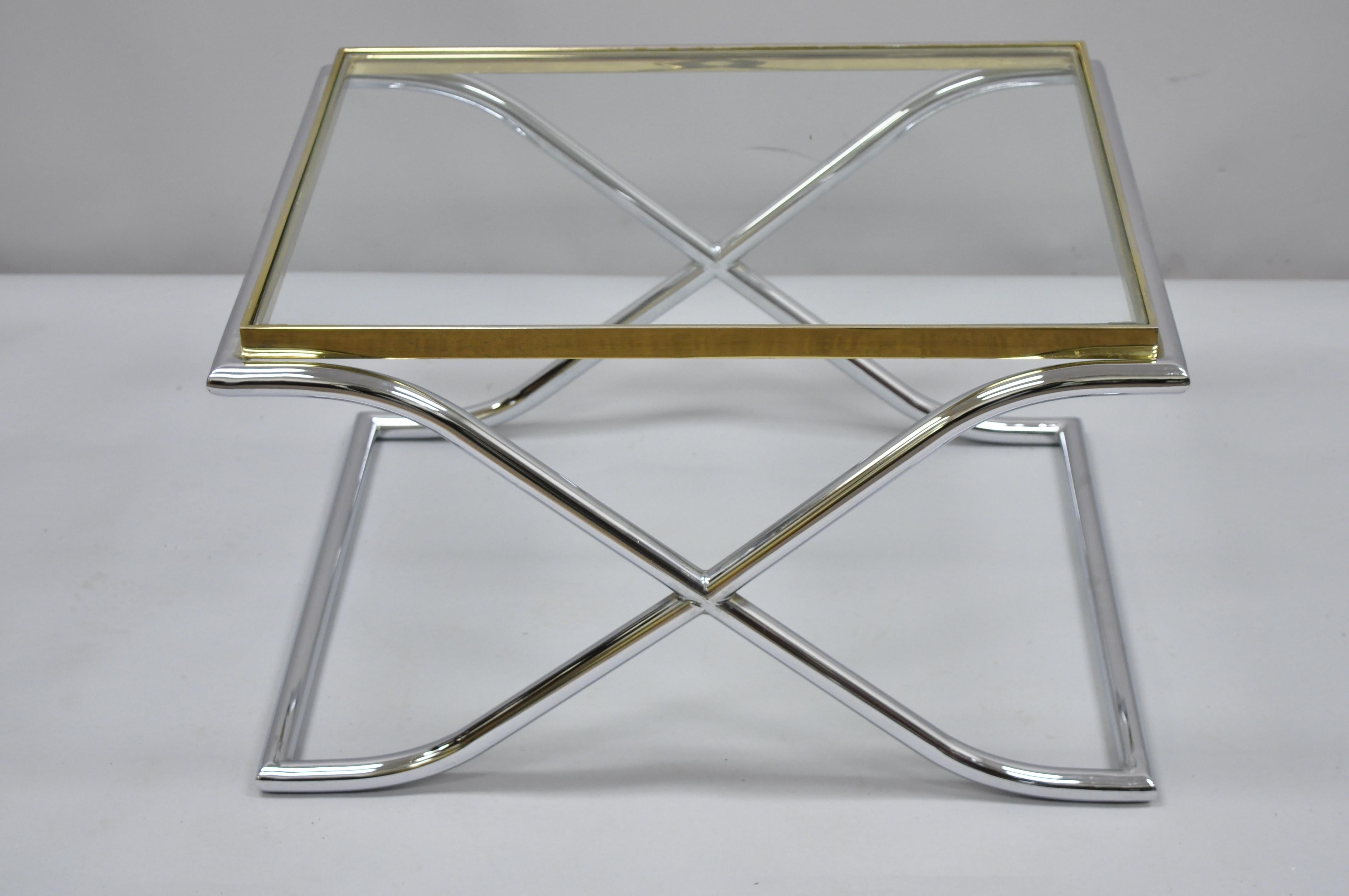 Vintage chrome, brass, and glass small Hollywood Regency X- frame coffee table. Item features chrome X- frame base, brass rim, inset glass top, great style and form, circa 1970. Measurements: 16.5