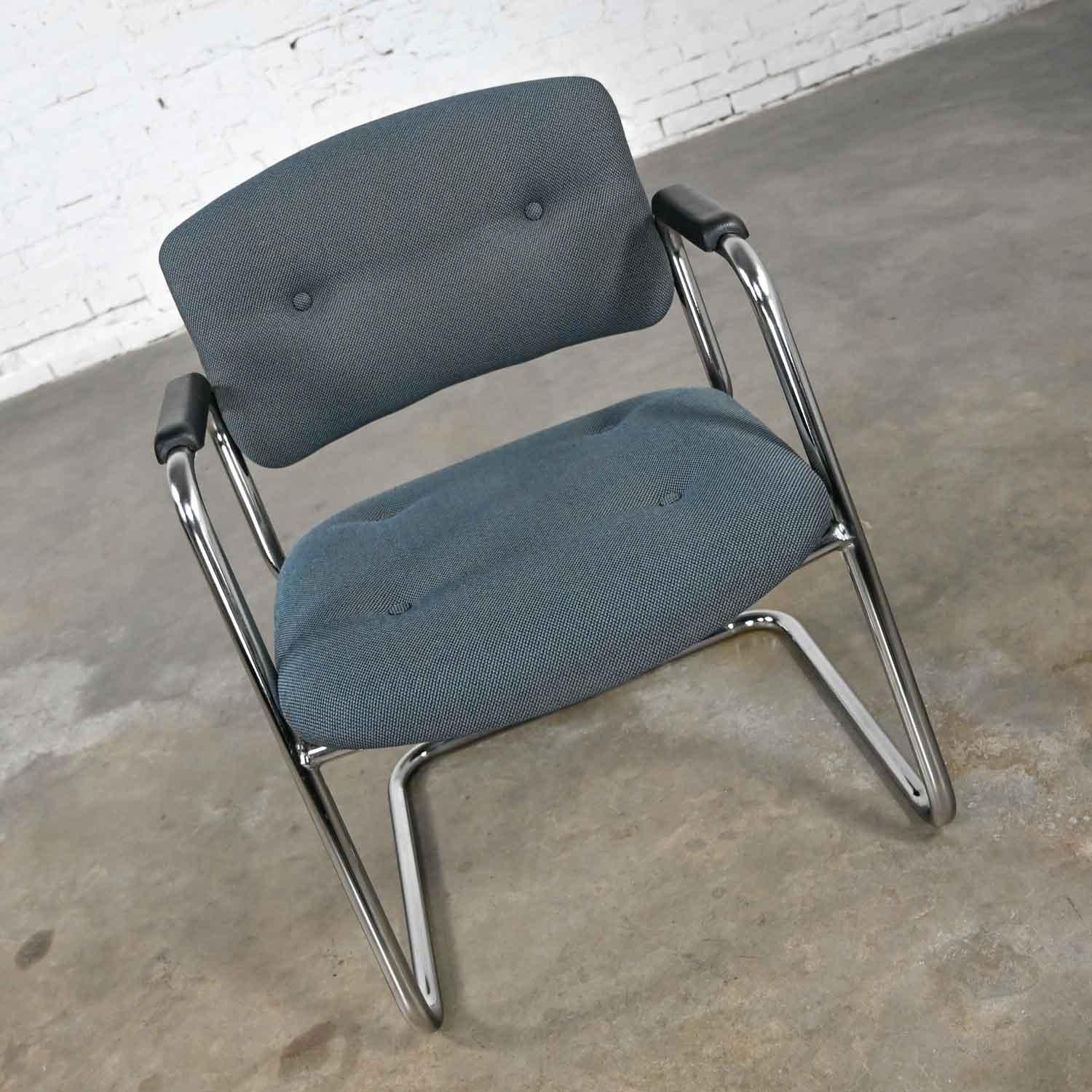 Awesome gray-blue & chrome vintage cantilever chairs by United Chair Company in the style of steelcase. Comprised of a chrome cantilever frame, black plastic armrests, and their original teal & gray tweed fabric with button details. We have 99