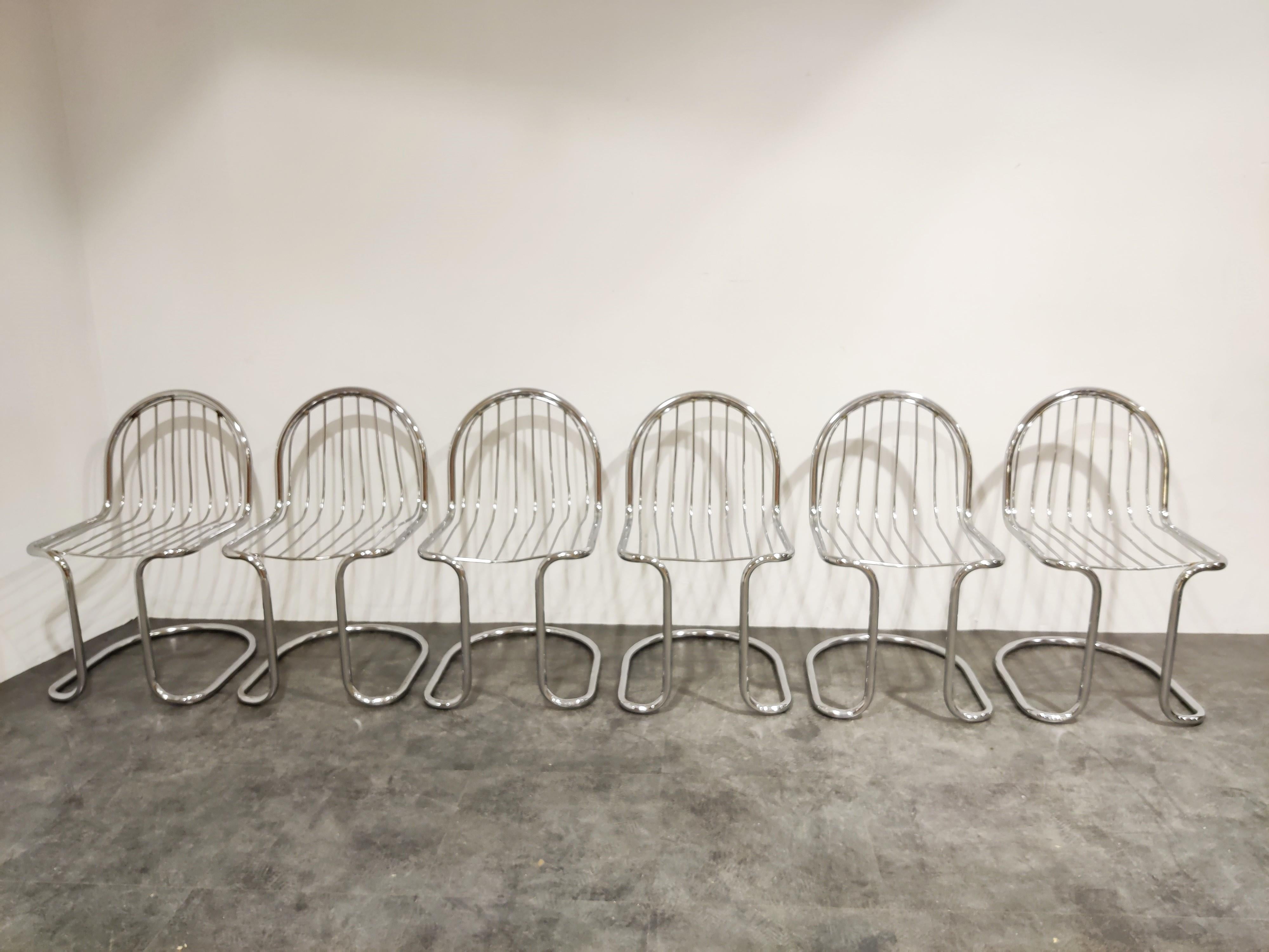 Midcentury chrome wire cantilevered dining chairs, set of 6.

Striking design with an unusually shaped base.

1970s, Italy

Attributed to Gastone Rinaldi, Giotto Stoppino

Dimensions:

Height 83cm/32.67