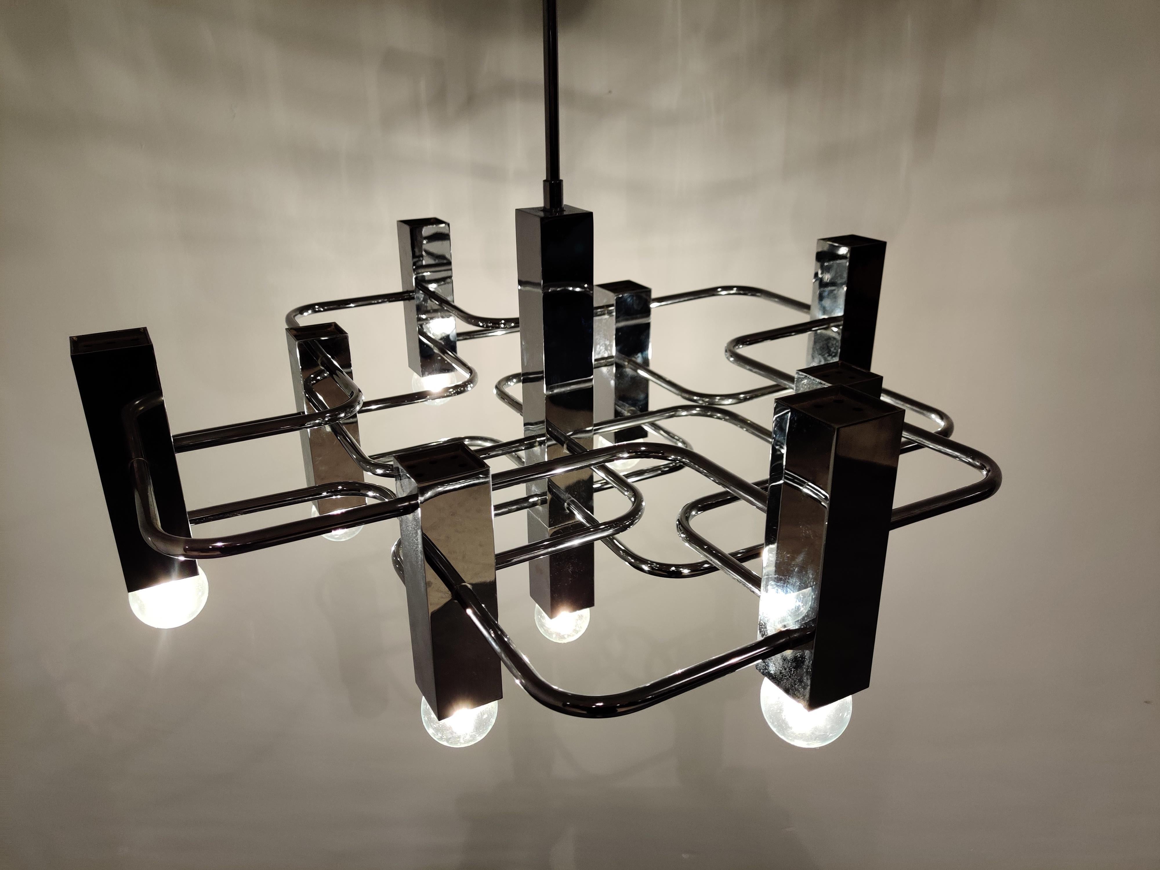 Architectural chrome chandelier with 9 lightpoint designed by Gaetano Sciolari for Boulanger.

Beautiful polished chrome.

Tested and ready for use with regular E14 light bulbs.

Works all over the world,

1970s, Italy

Dimensions:
Height