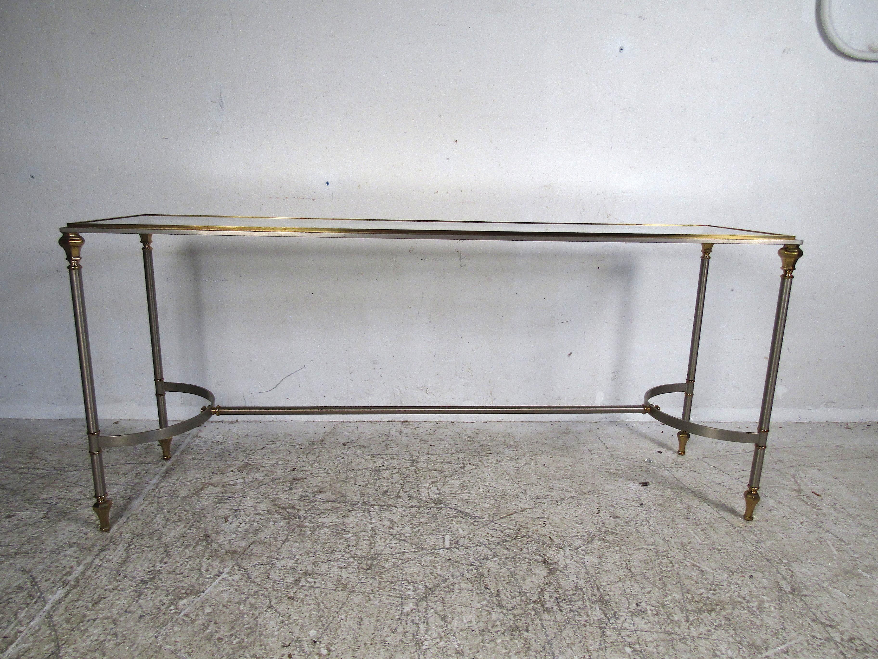 Nice vintage console table with a chrome frame and brass accents. Glass insert serves as a tabletop. Please confirm item location (NJ or NY). 
  