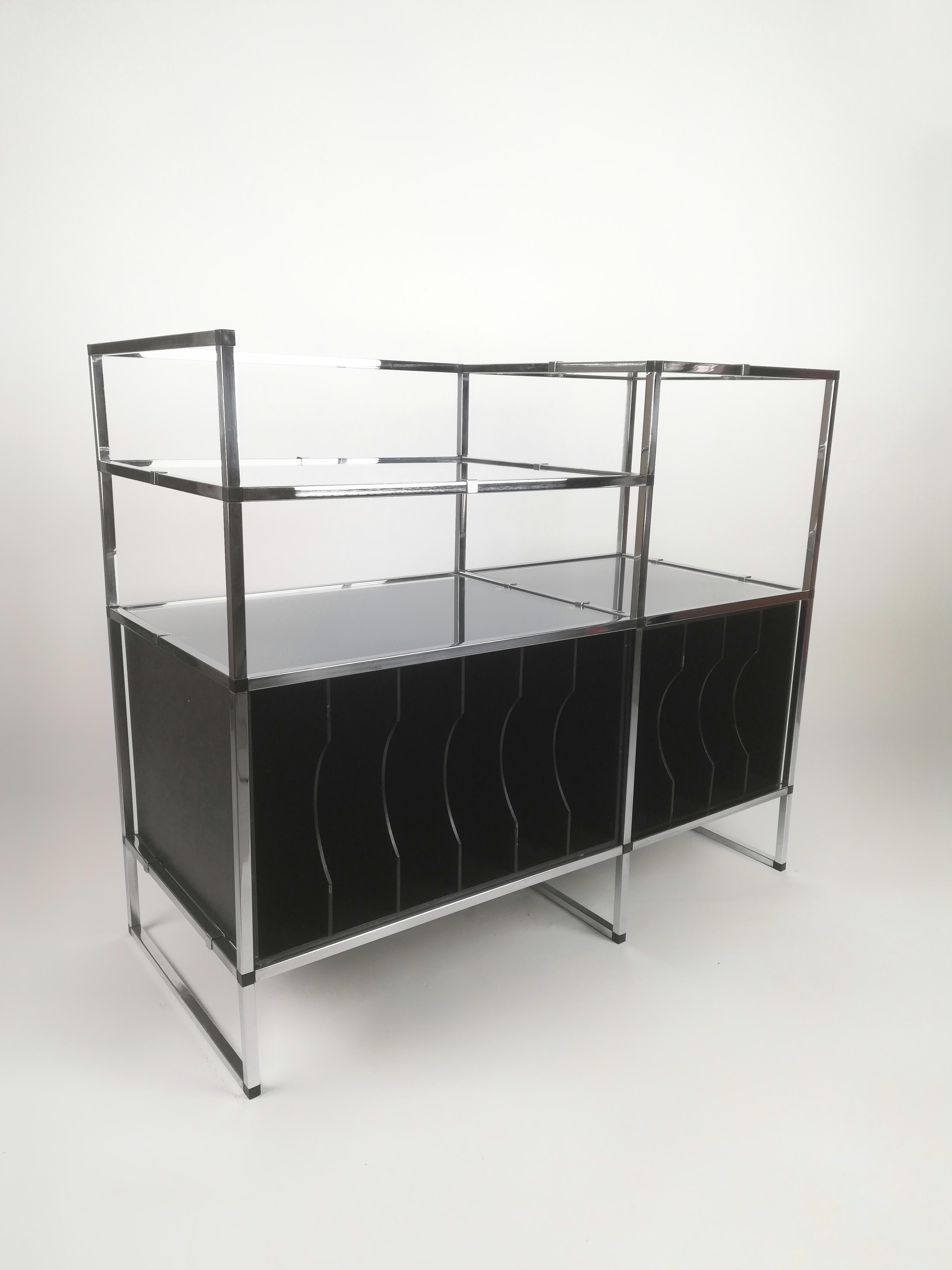 A Vintage Record Player Stand and vinyl storage but also an étagère or a consolle table if you remove the plywood cases for vinyl records. 
It was made in Italy during the 1970s using chromed metal parts joined together with small abs dices.
The