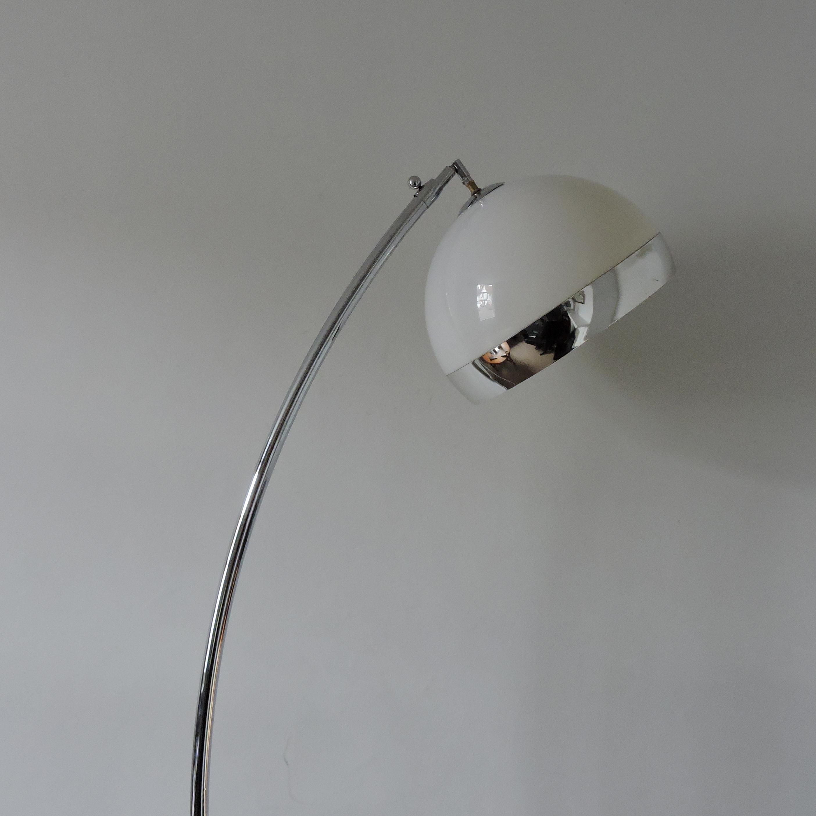 This arc lamp has a marble base, chromed metal rod, and white plastic shade. The base measures 38cm depth 25cm width x 6cm high.