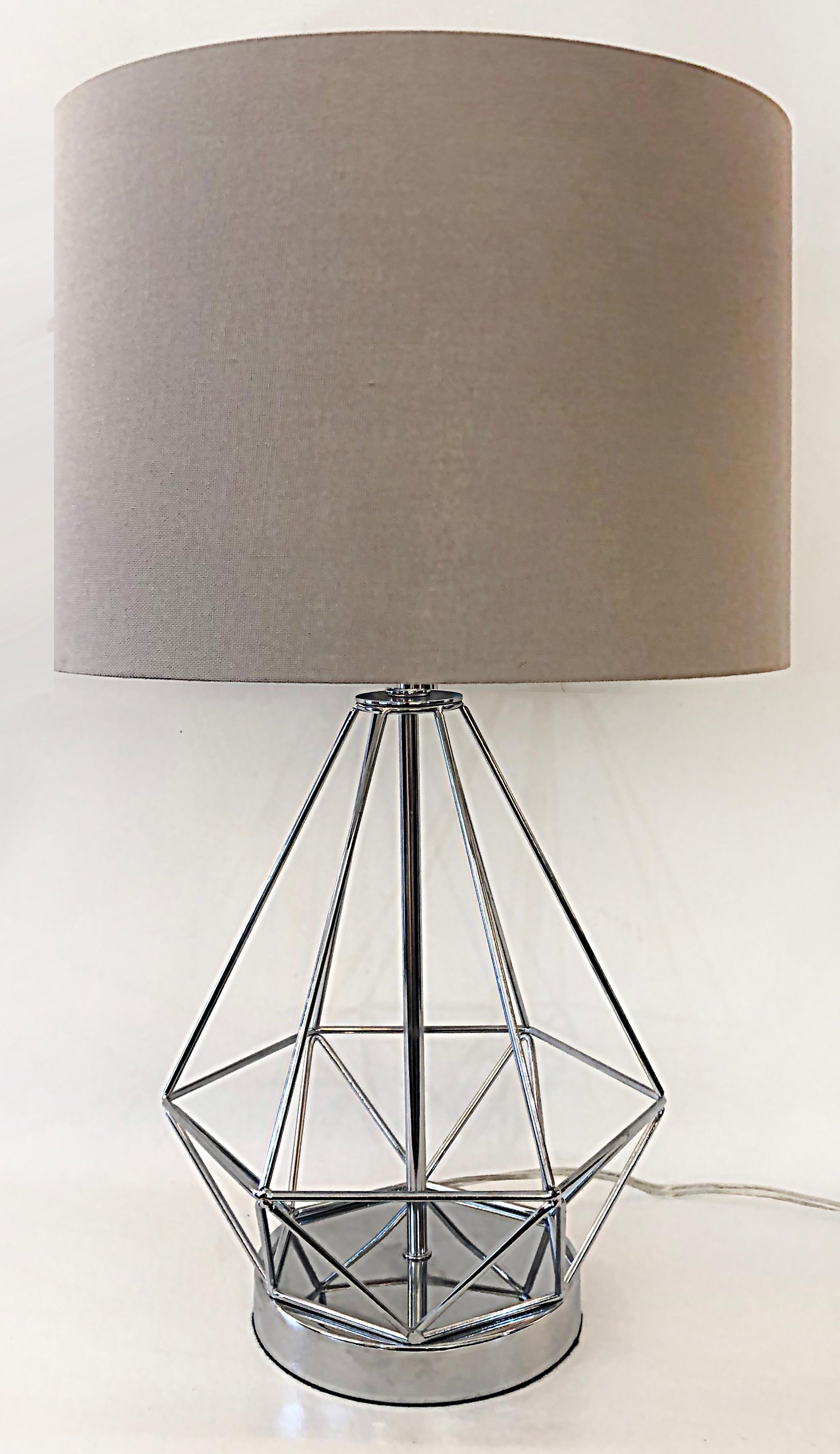 Vintage chrome geometric table lamps, USB charging port on base.

Offered for sale is a vintage pair of chrome geometric form table lamps with drum shades included. The lamps have geometric chrome forms supported by round chrome bases. You can see