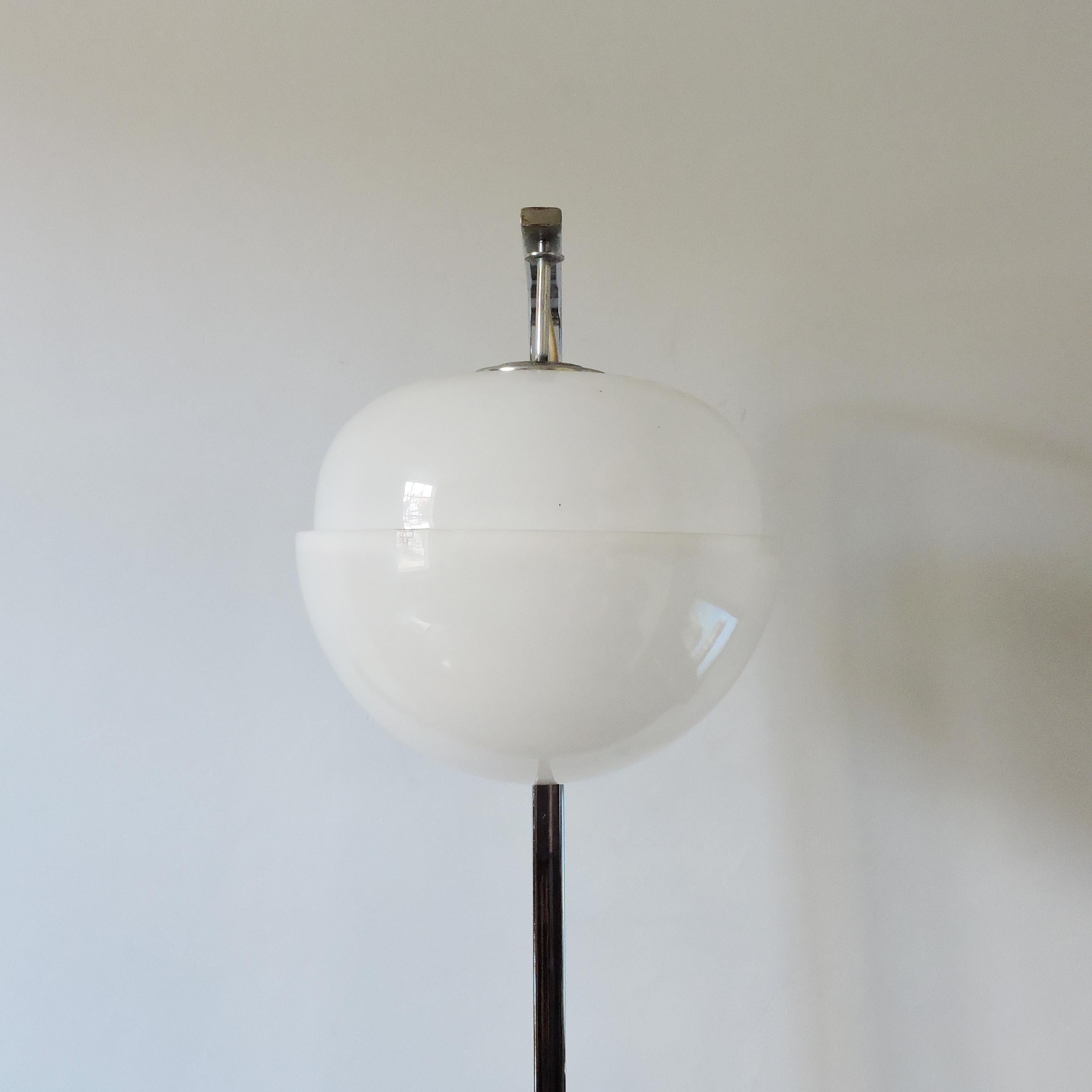 A 1970s tall chrome floor lamp featuring a suspended plastic globe.