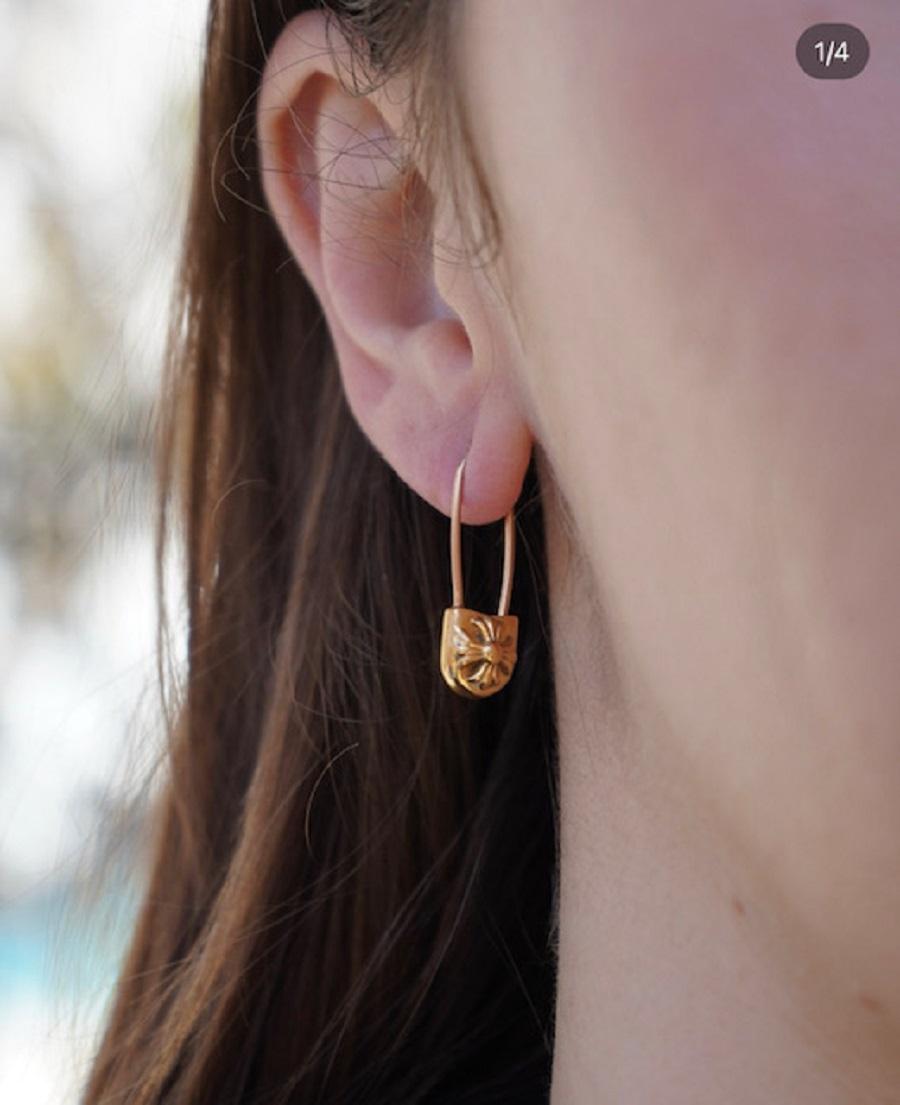 A pair of safety pins by Chrome Hearts, crafted of 22k gold. 
The pins can we worn as earrings (see photos). An emblematic ChromeHearts cross motif, created by using a repoussé technique, set on top of the pin. This relief work gives the piece depth
