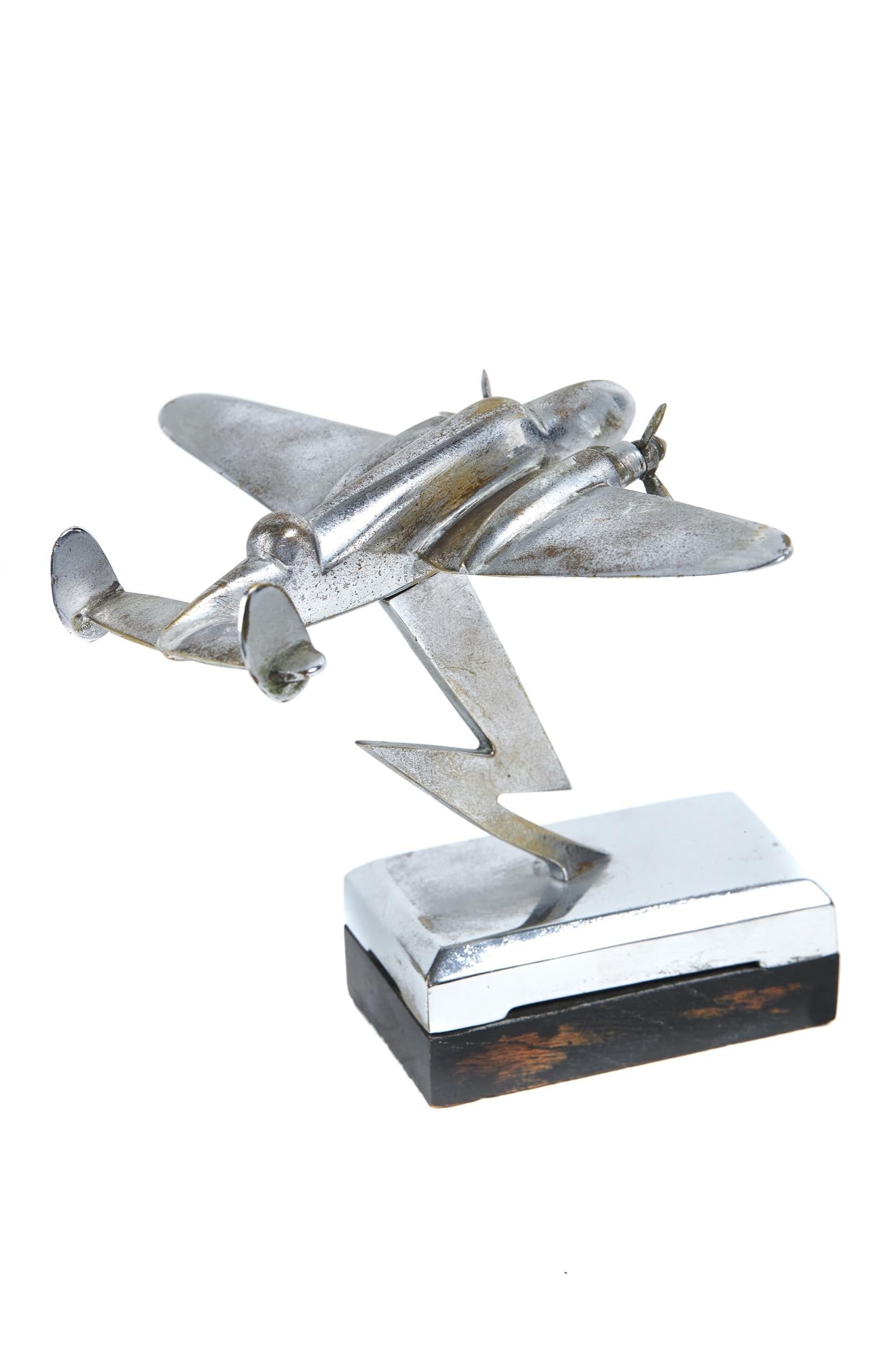 vintage Chrome model of WW11 Bomber Airplane on stand 
Circa 1930s
Chrome plated on Brass, 
Lightning Stylised support 
Chrome Rectangular base mounted on black wood base
Green Baize Underneath
Chrome Plated Worn