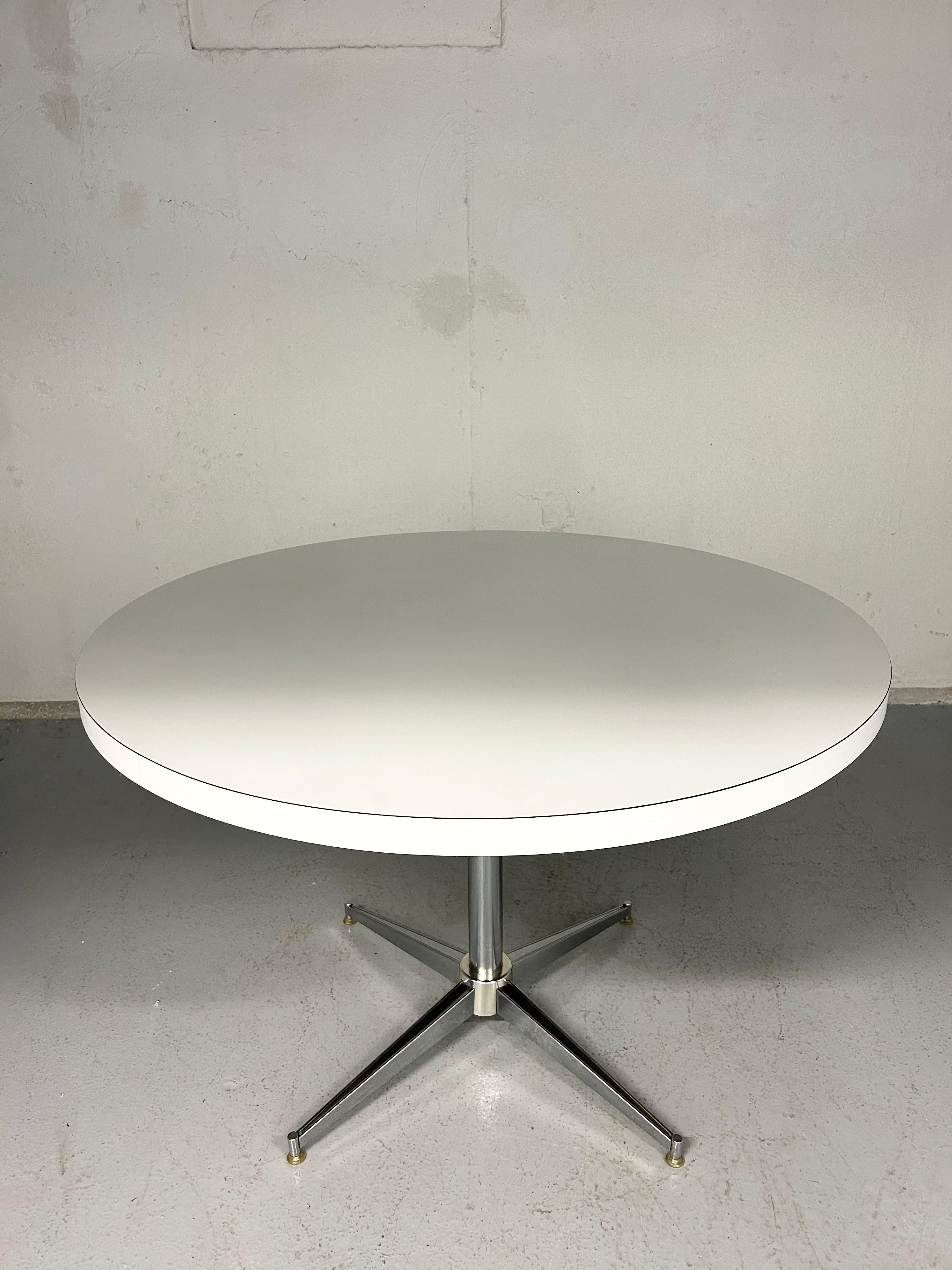 Vintage chrome pedestal dining table. Round white laminate top. Chrome base. No chips in the laminate, no rust on the chrome. Minimal wear.