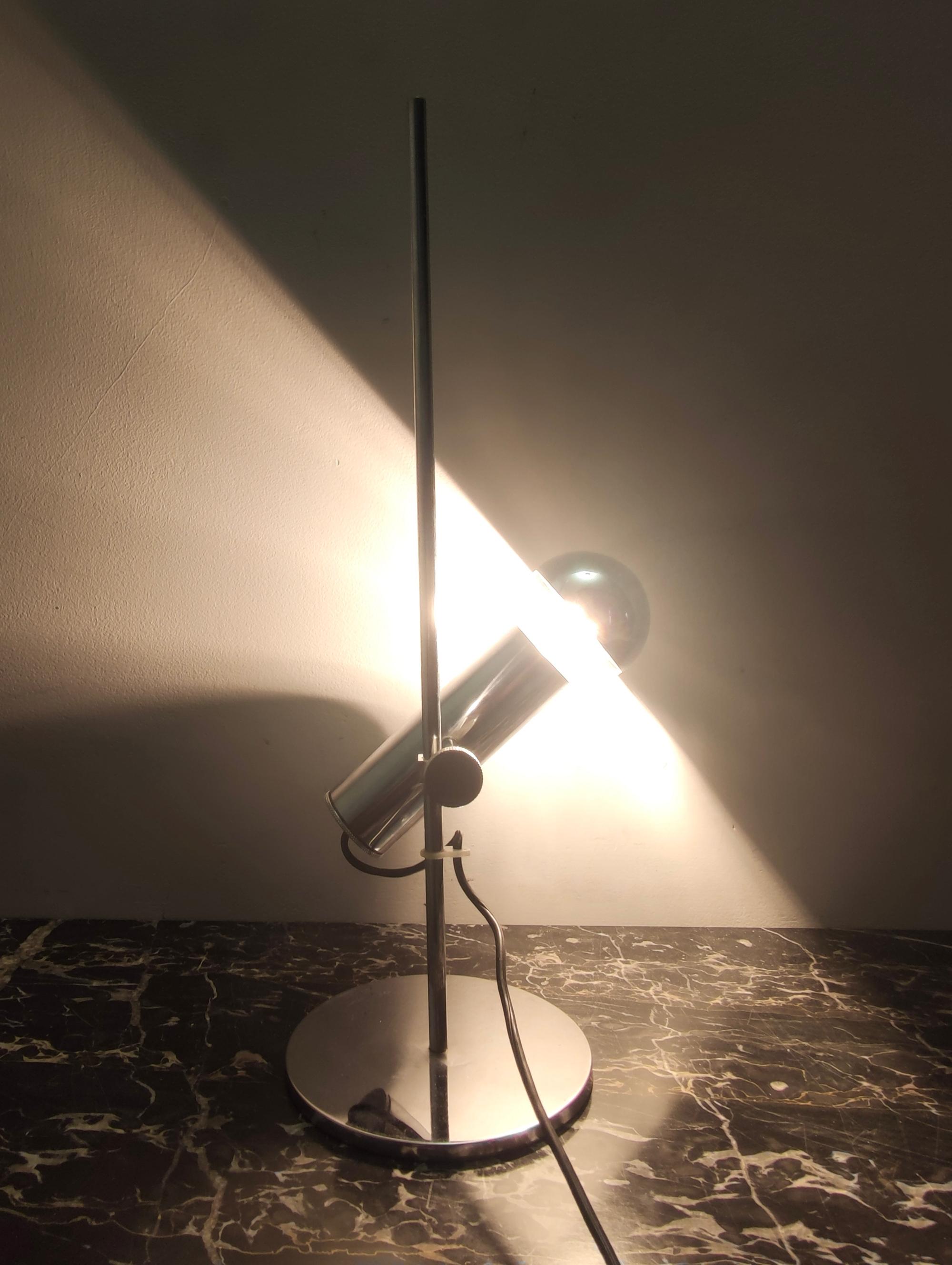 Made in Italy, 1960s.
This table lamp is made in chrome-plated brass.
With its fine system of junction, its position and its light can change.  
This lamp is vintage, therefore it might show slight traces of use, but it can be considered as in