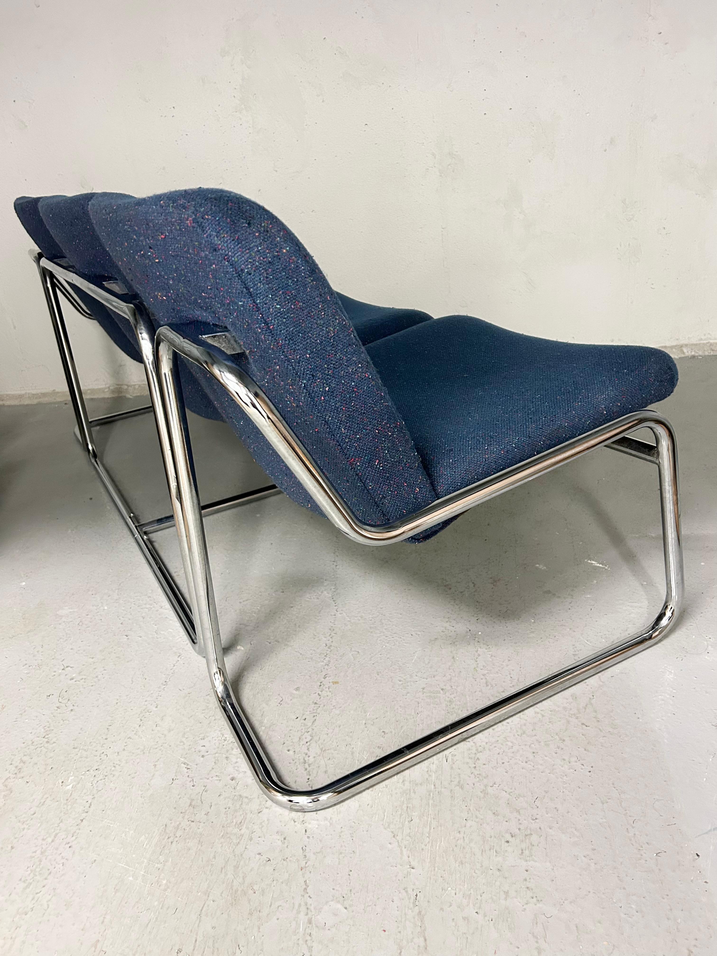 Vintage chrome sofa or bench with cushioned blue specked tweed upholstery. No manufacturer markings. Chrome has minimal wear - upholstery has normal wear. No rips, tears, or major stains. Has light subtle spots but minimal. 