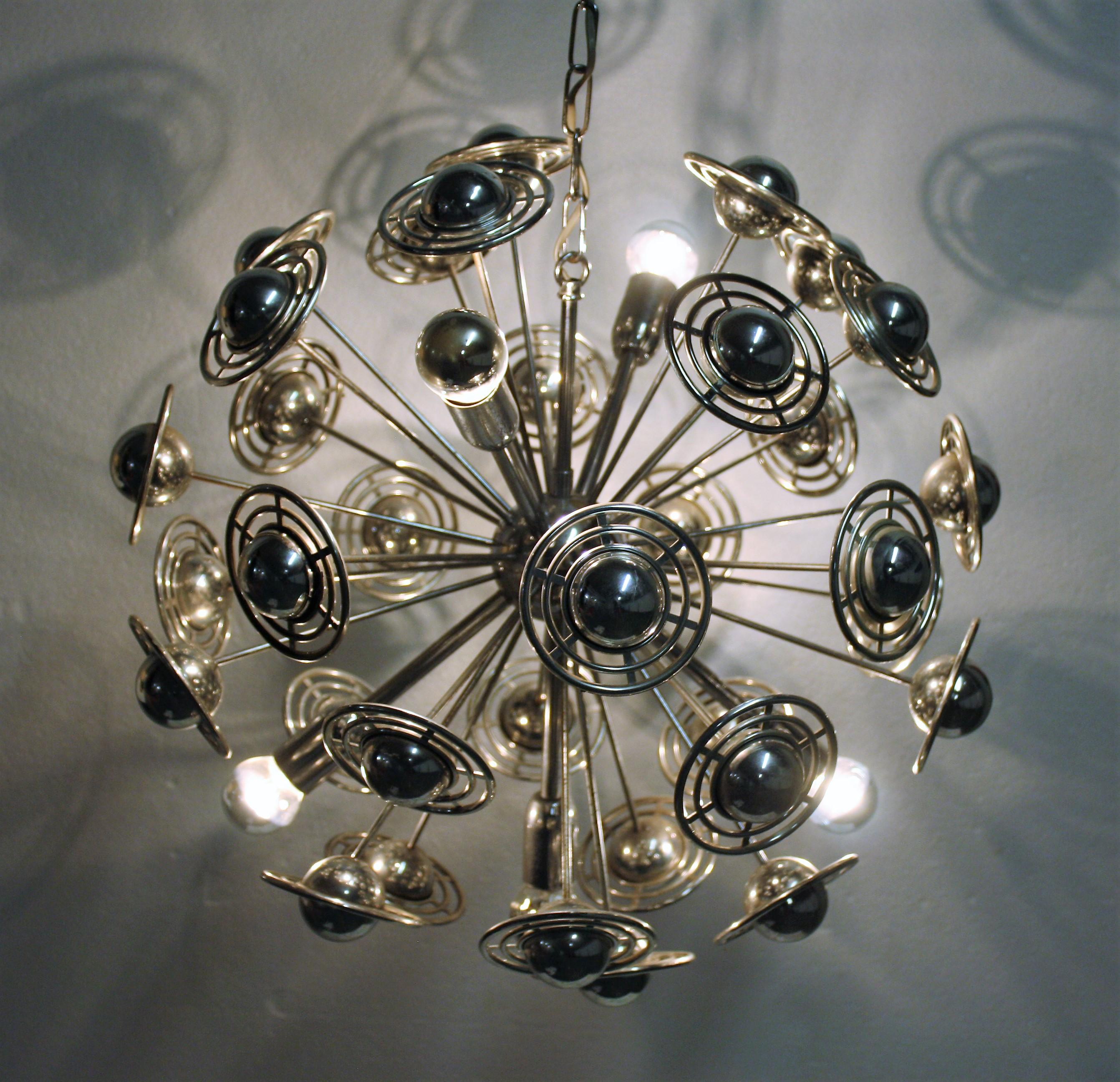 Sputnik chandelier with patinated chrome metal sockets, arms and body interspersed with chrome plated plastic spheres.

The chandelier creates a beutiful effect.

This is a more rare model with the saturn like spheres.

Tested and ready for