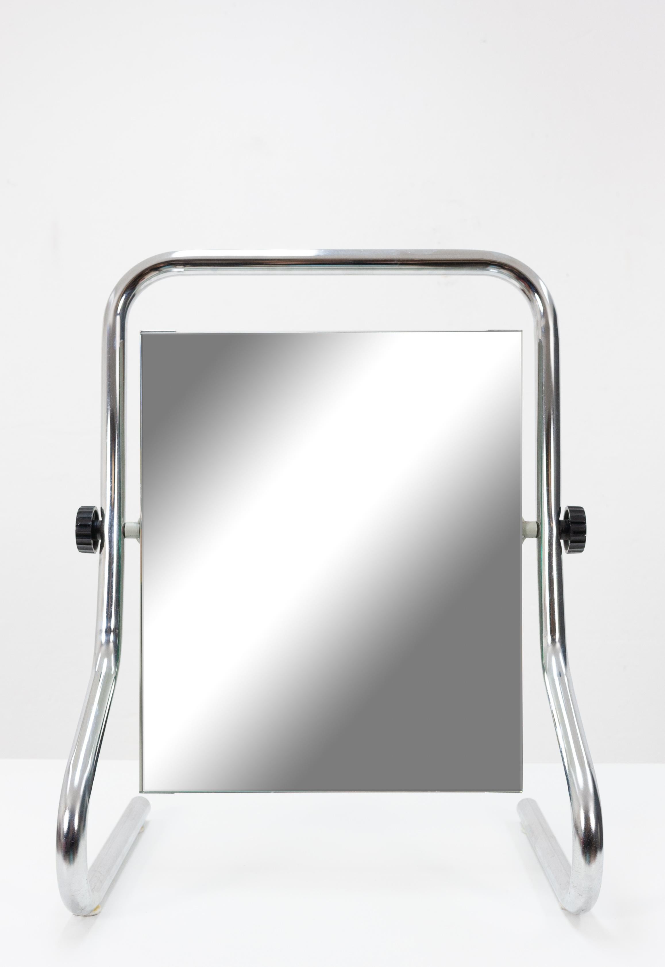 Vintage table mirror. Chrome tube frame, with a mirror in-between. Adjustable. Very good condition.

France, 1970s.

  
